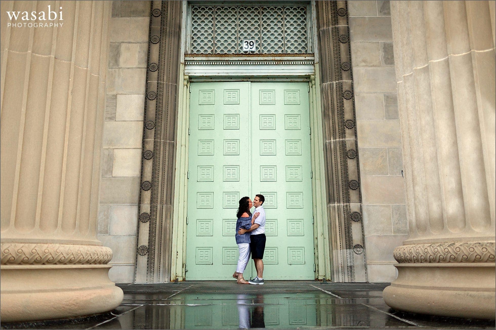A couple laughs during their engagement session at The Museum of Science and Industry near Chicagos Jackson Park and Hyde Park neighborhood between Lake Michigan and The University of Chicago.