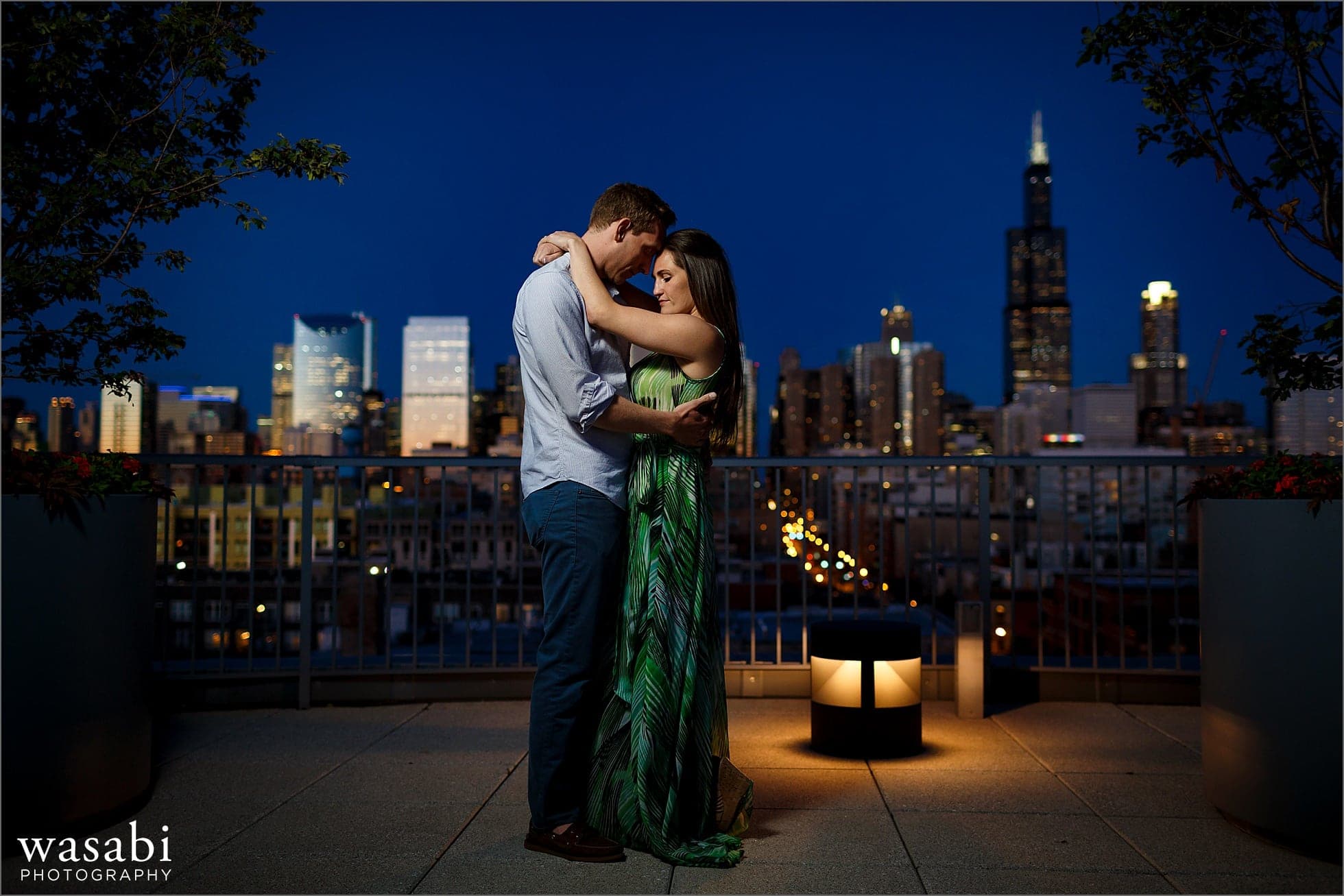 west loop engagement photos on roof deck of Madison at Racine with skyline view of Chicago