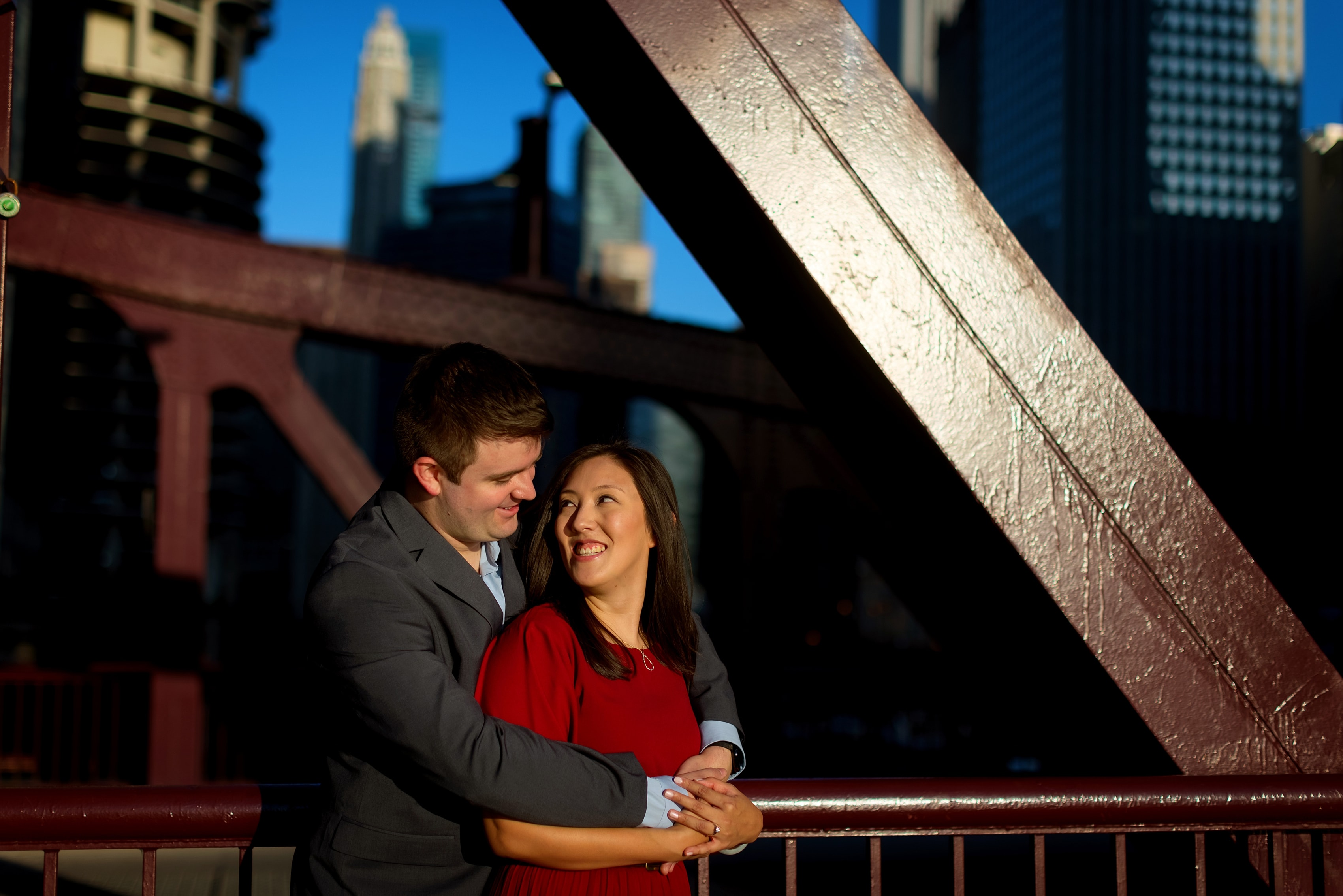Couple poses for engagement photos on LaSalle Street Bridge in downtown Chicago