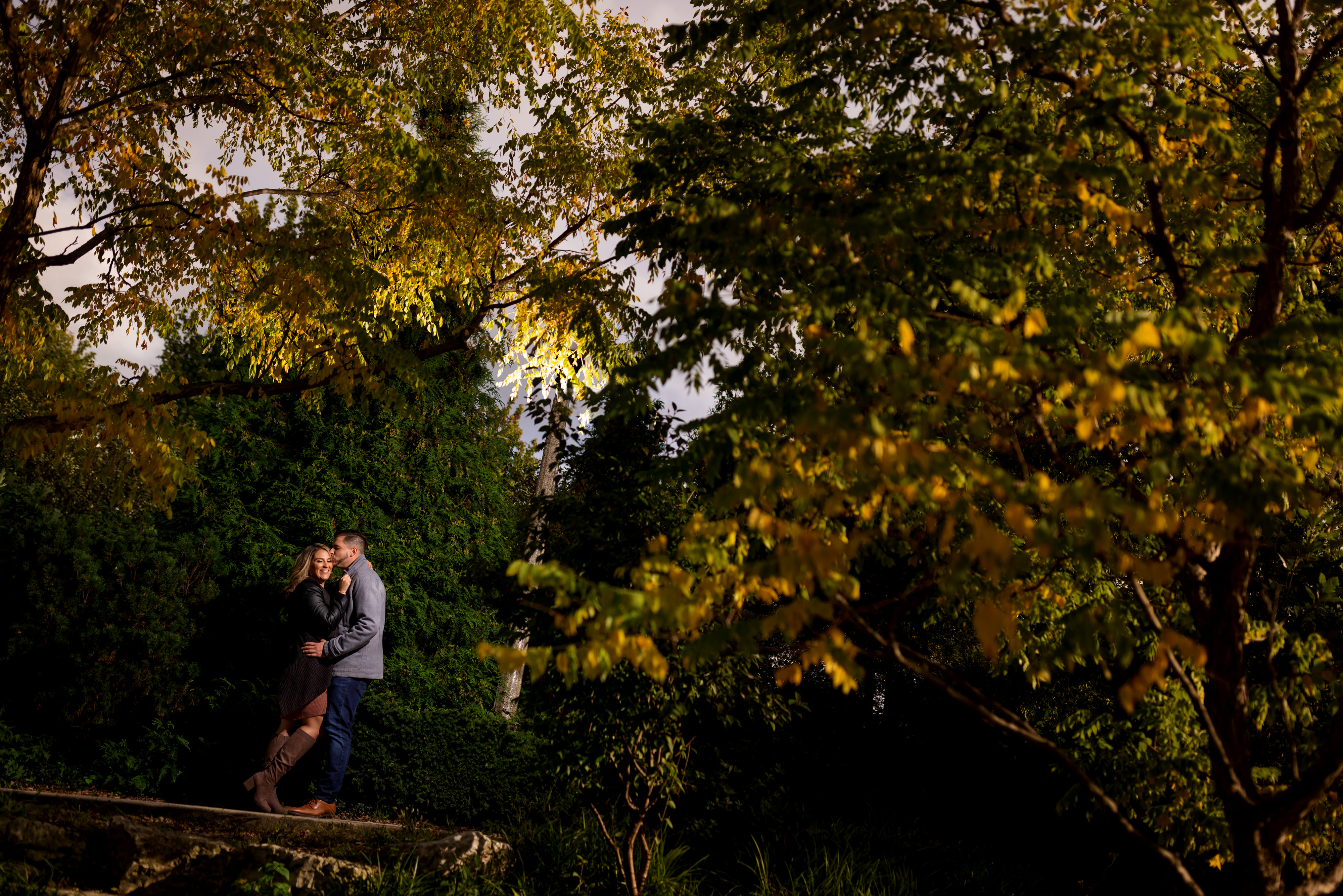 couple poses for engagement photos on the 606 trail in Chicago's Wicker Park neighborhood