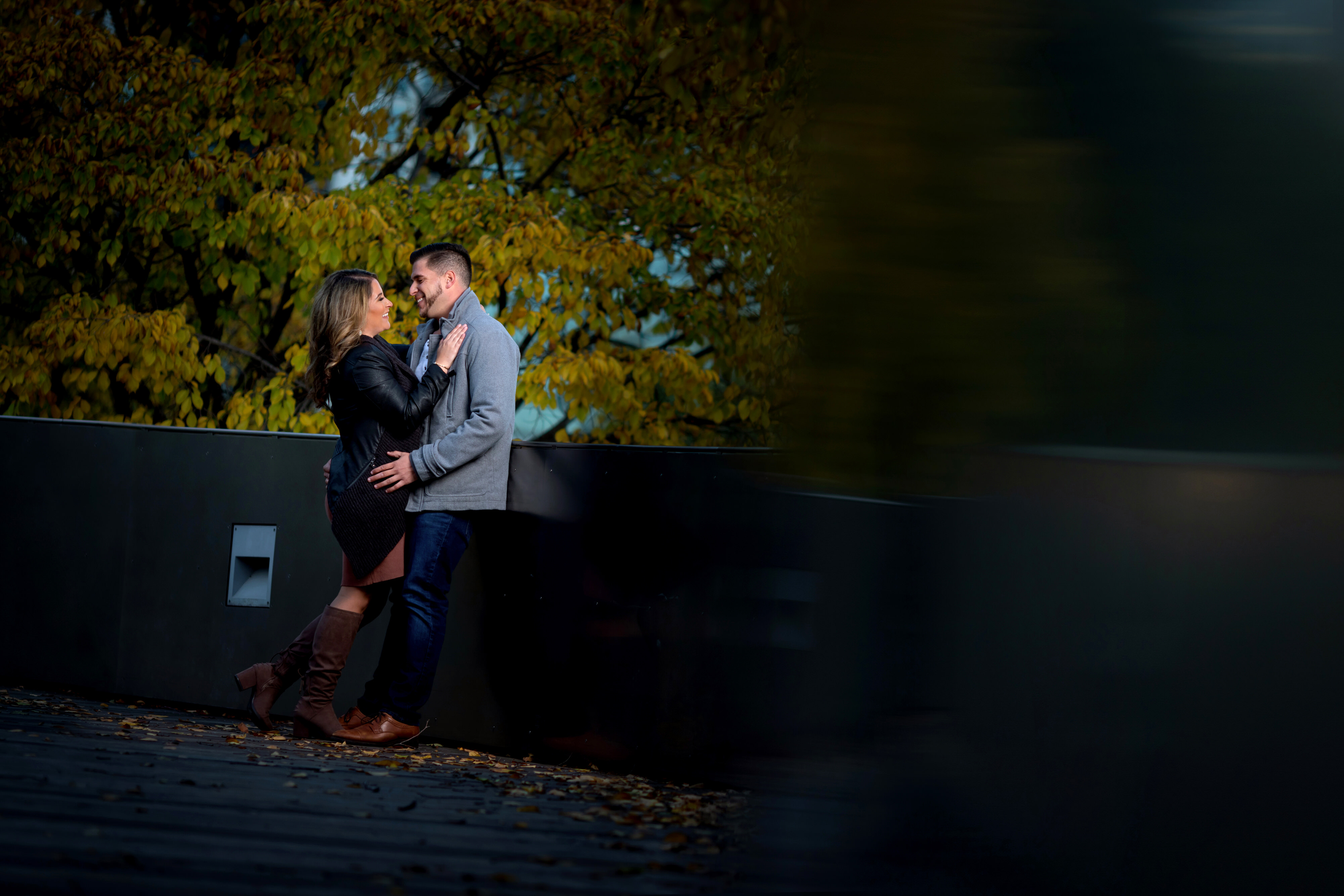 couple poses for engagement photos in Lurie Garden at Millennium Park in downtown Chicago
