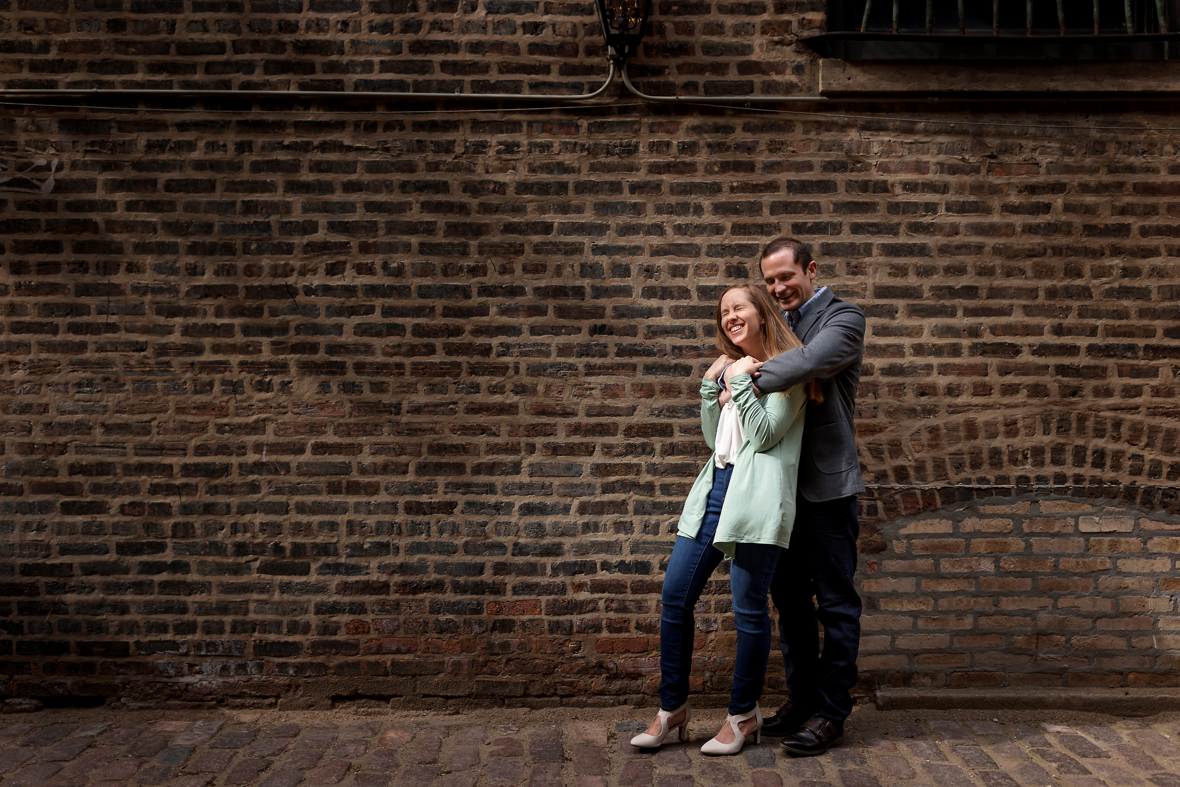 Wedding couple poses for engagement photos in Chicago's West Loop neighborhood near Green Street Smoked Meats