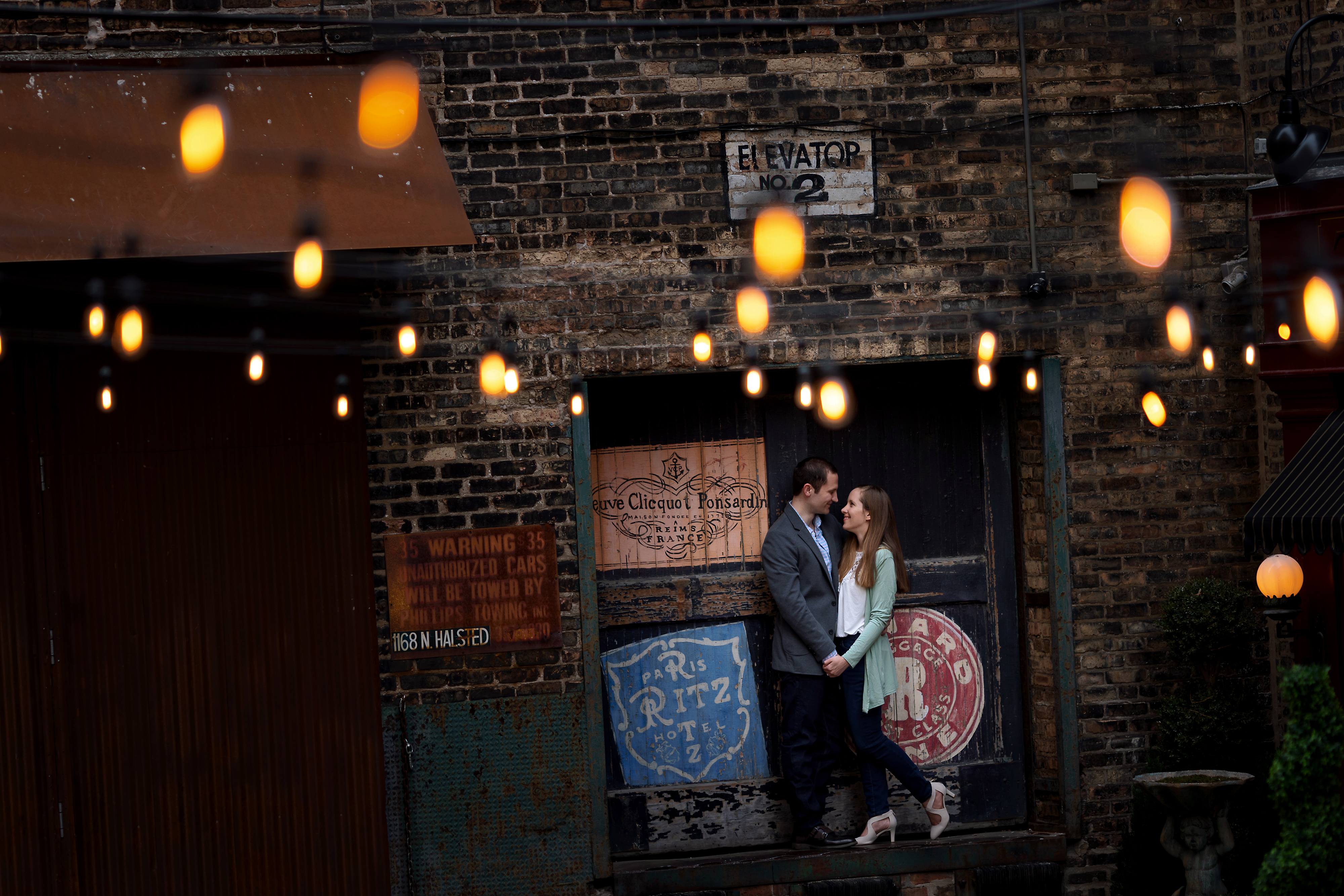 Wedding couple poses for engagement photos in Chicago's West Loop neighborhood near Green Street Smoked Meats