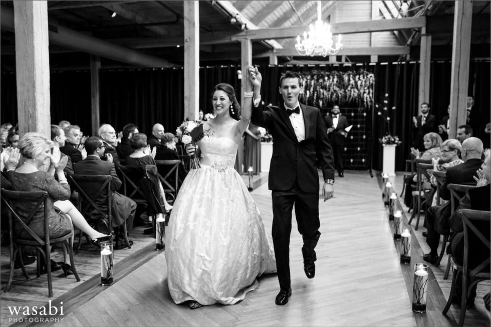 Bride and groom walk down the aisle after being married at Bridgeport Art Center Skyline Loft