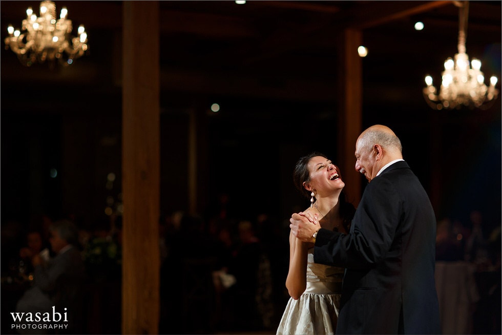 bride laughing and dancing with dad during father daughter dance