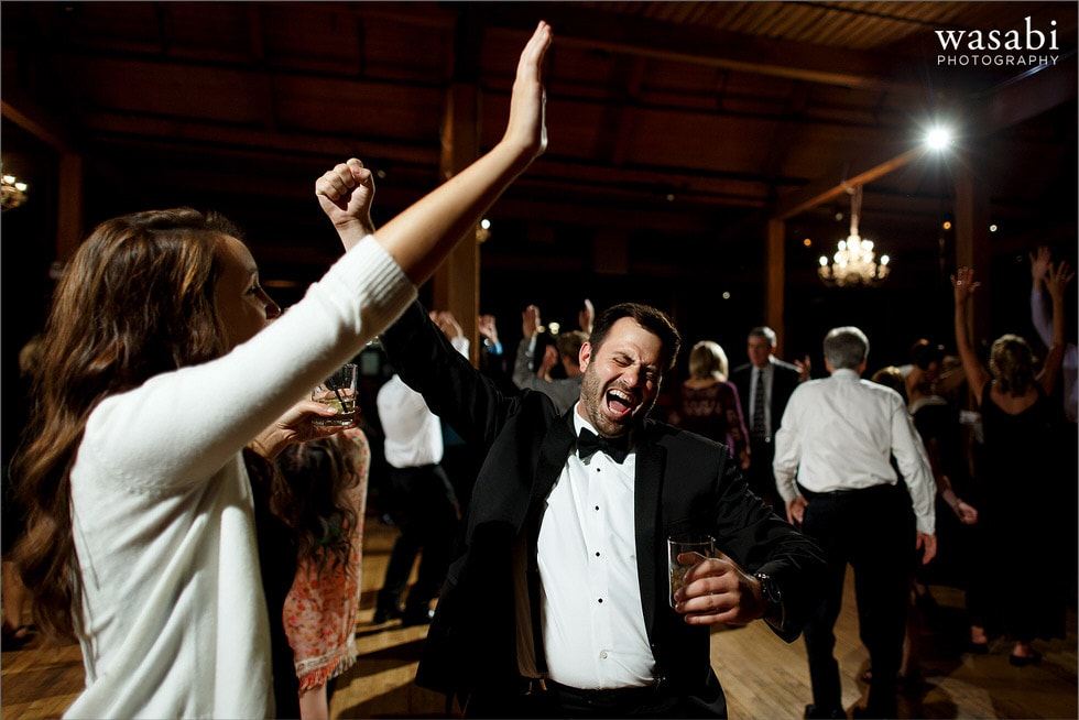 wedding guests arms up in the air during reception dancing