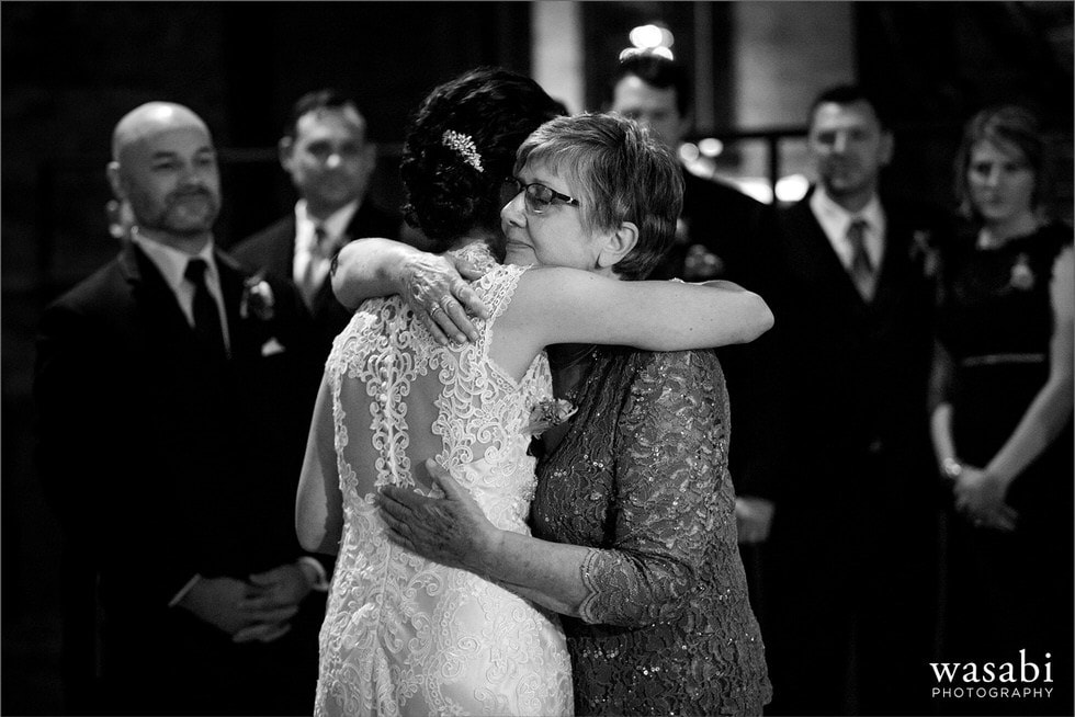 Mom hugs bride wedding ceremony