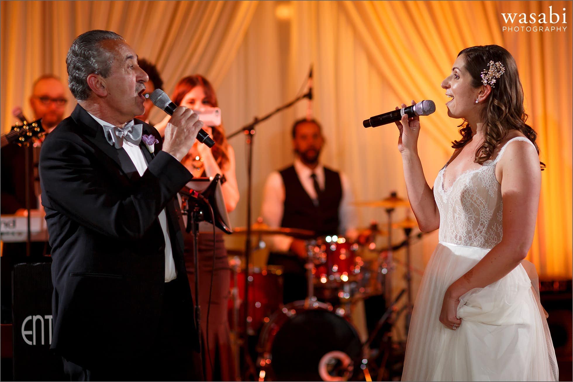 groom and father sing a duet for their first dance during wedding reception at The Rookery Building in Chicago