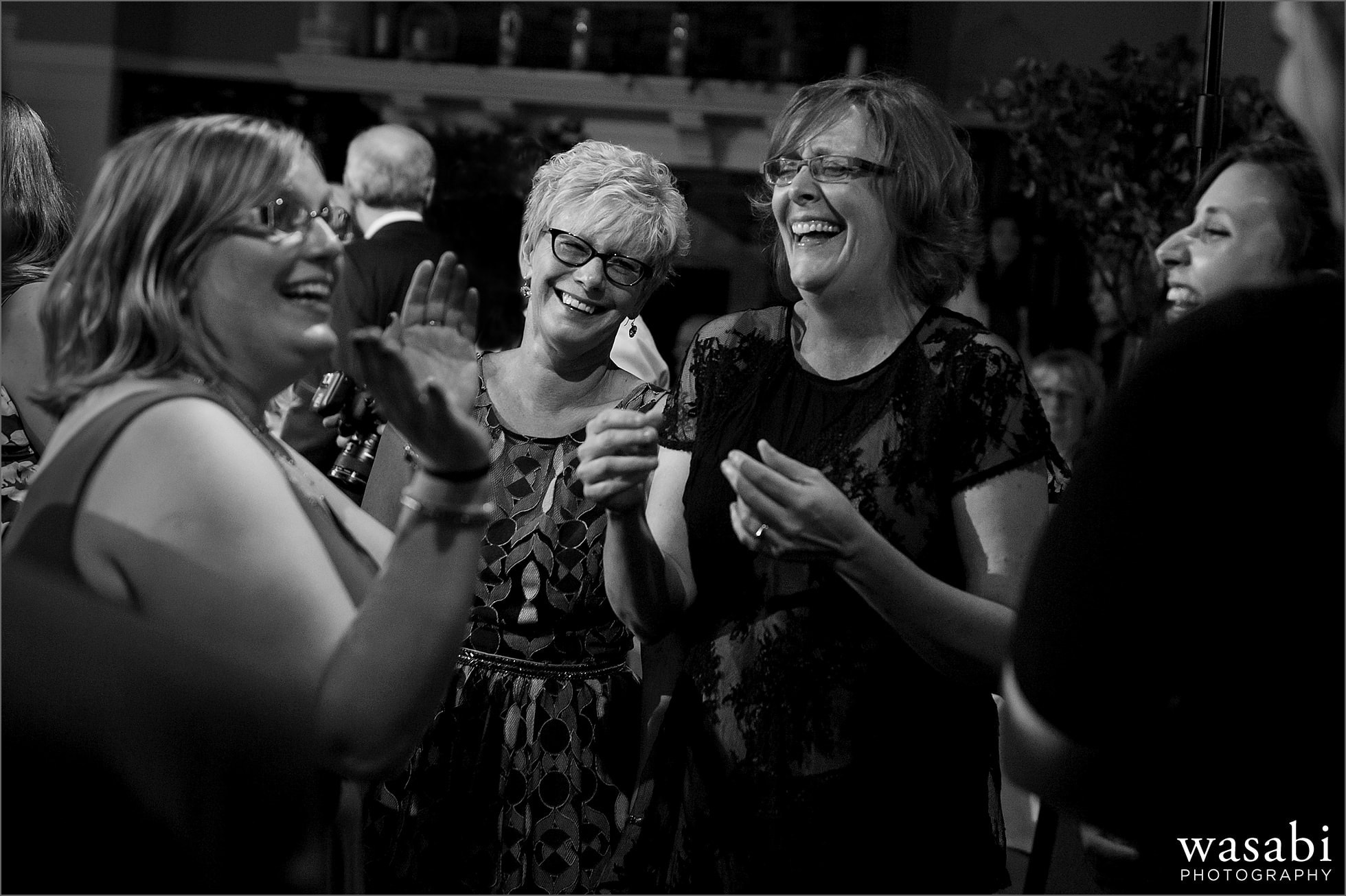 black and white women dance during wedding reception at Oakhurst Country Club wedding in Clarkston, Michigan