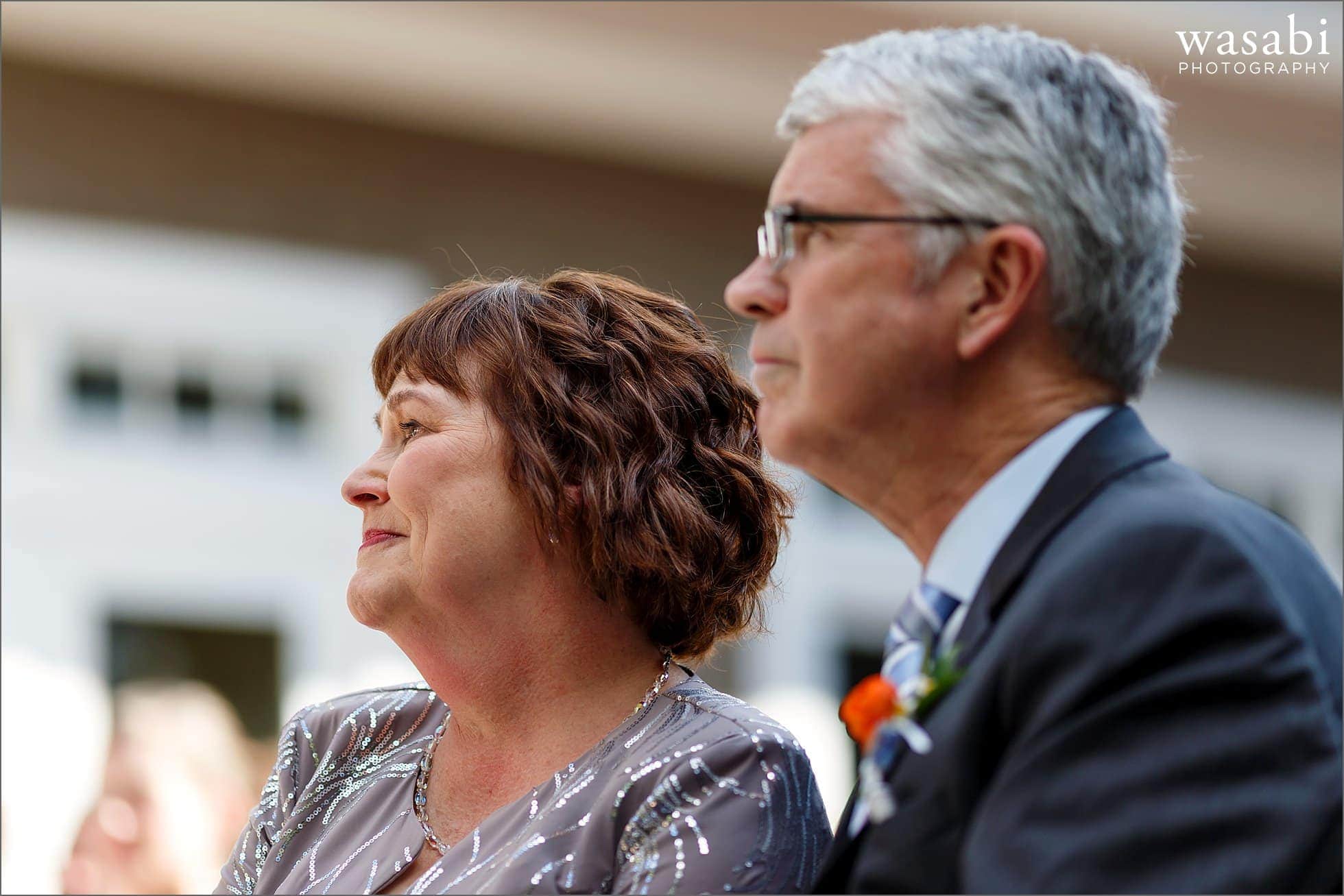 parents watch wedding ceremony at Oakhurst Country Club in Clarkston, Michigan