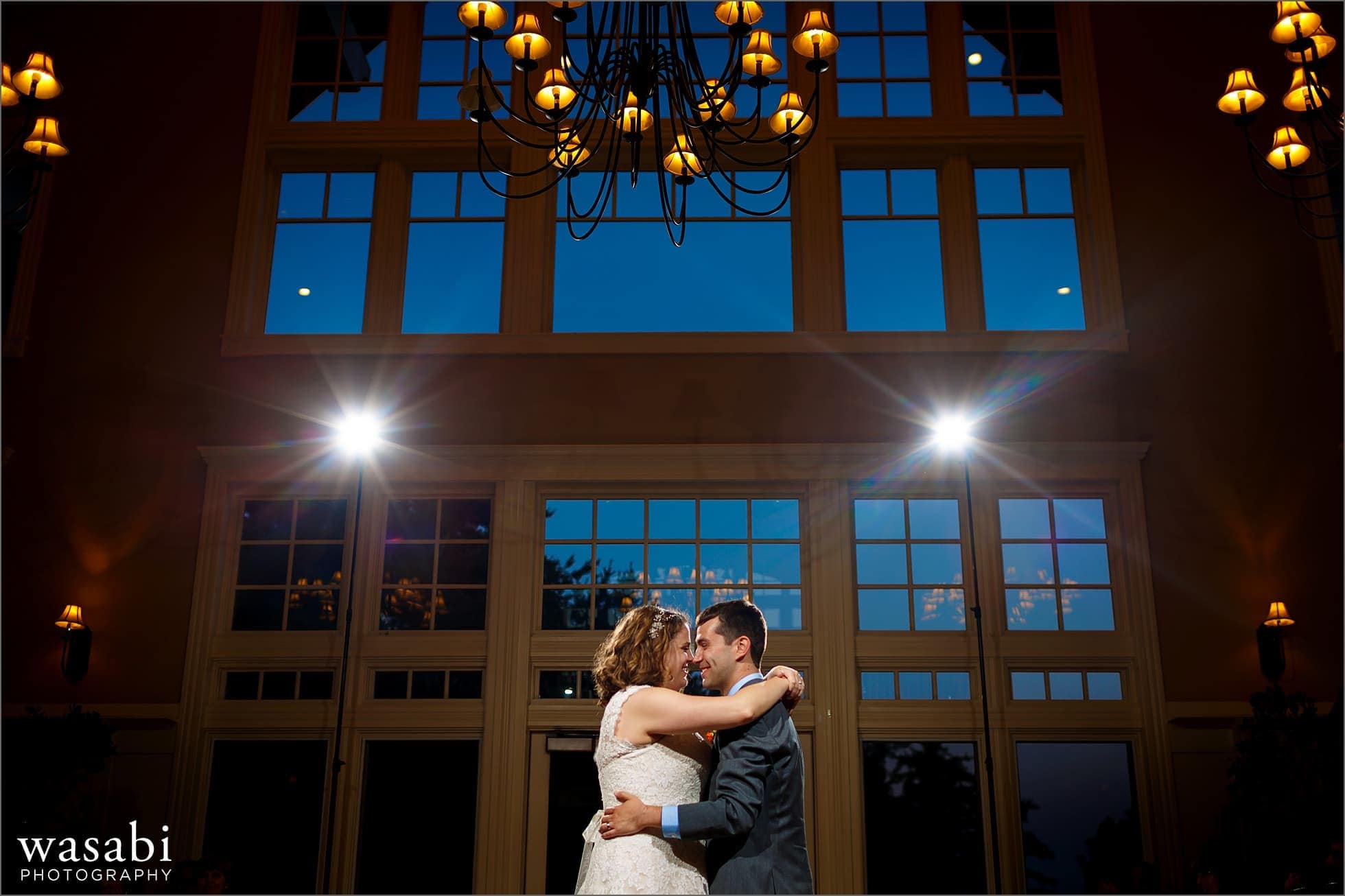 wide angle picture showing giant glass window during first dance at Oakhurst Country Club wedding in Clarkston, Michigan