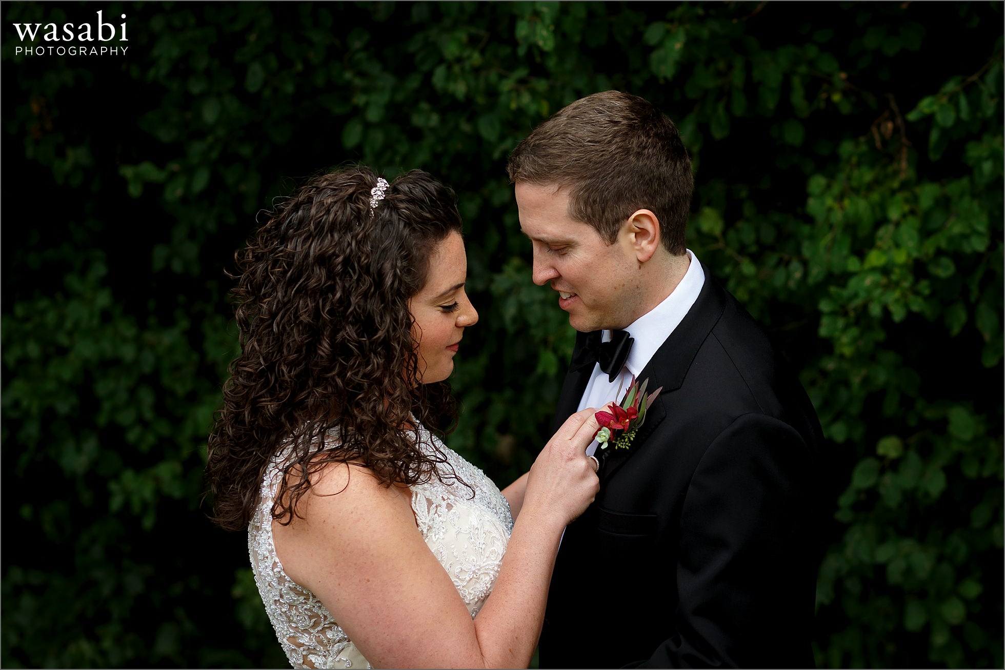 bride and groom see each other during first look in front of green trees at Lombard Westin Hotel