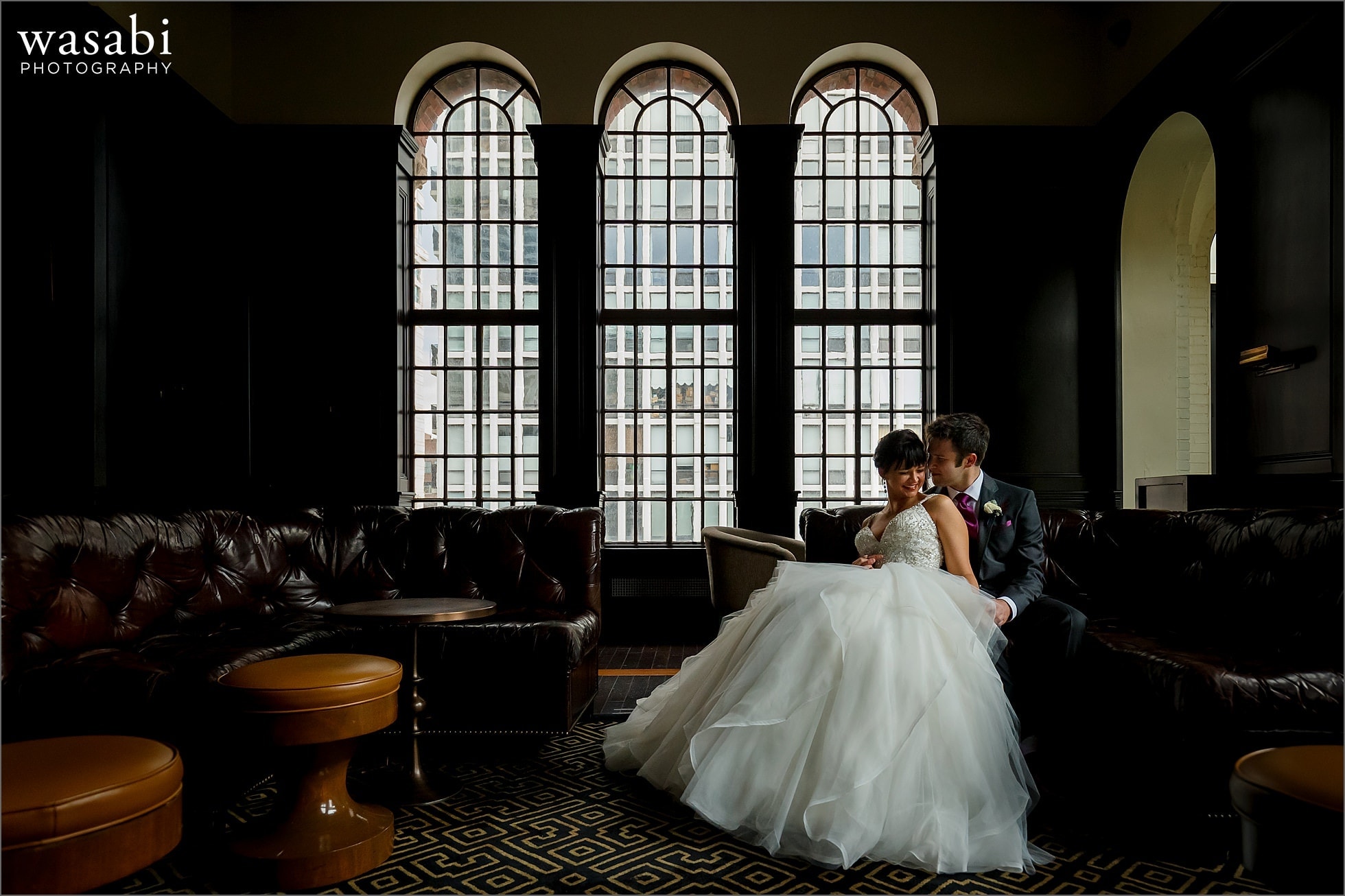 bride and groom pose for wedding portrait at Drumbar in Rafaello Hotel in Chicago