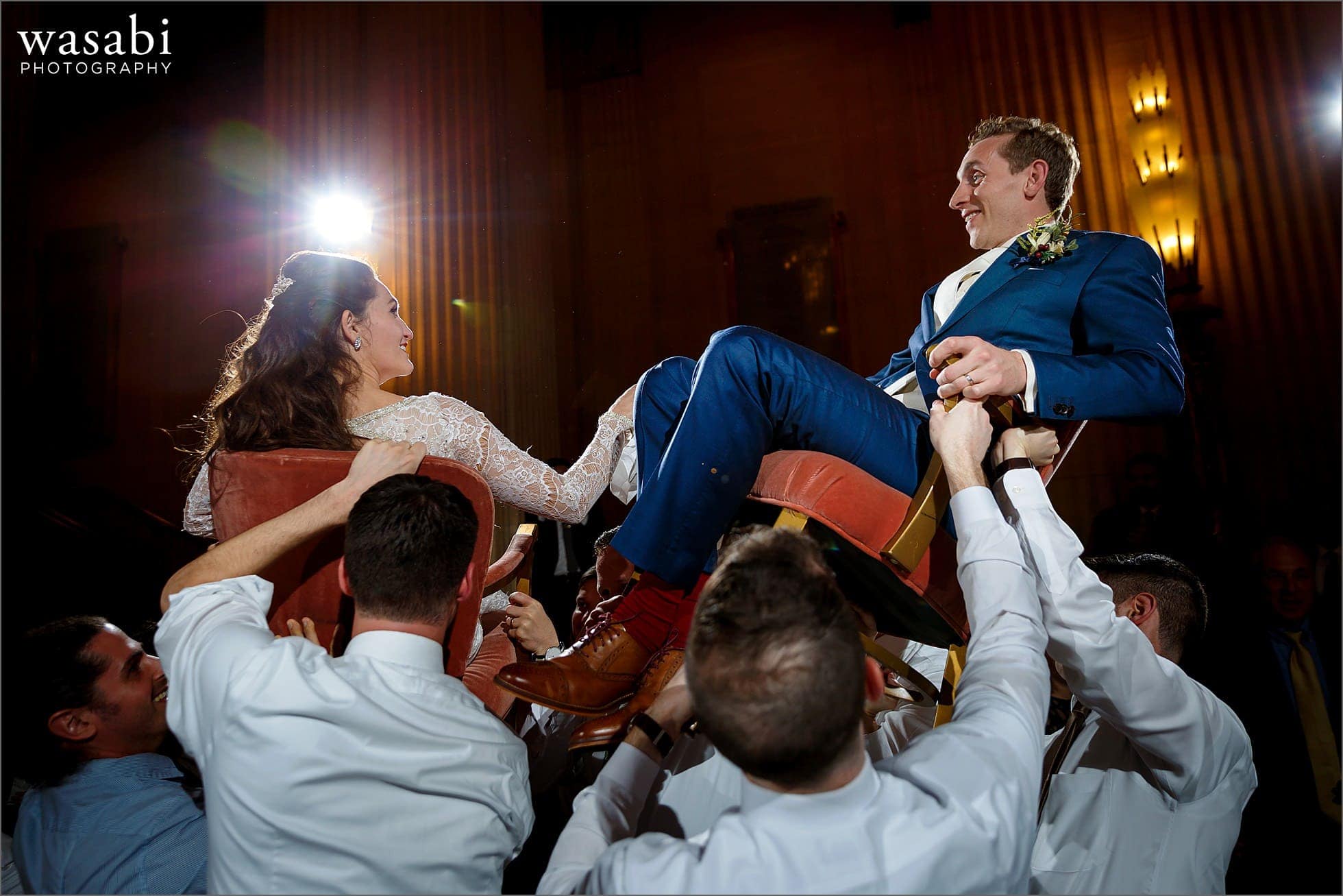 couple lifted up on chairs during the horah dance at Lyric Opera of Chicago wedding in Chicago
