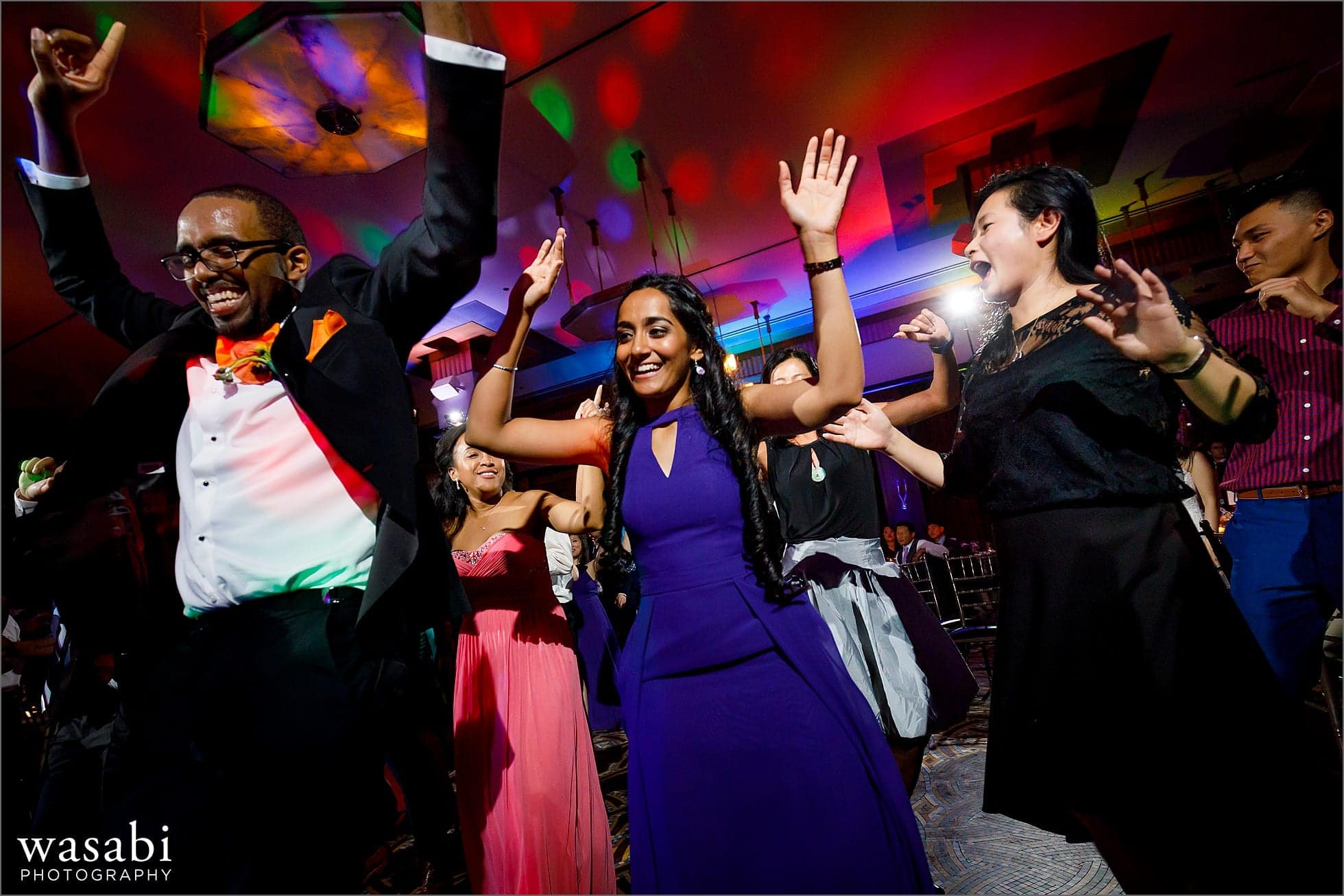 wedding guests on the dance floor with awesome color up lighting during Montgomery Club wedding reception in Chicago