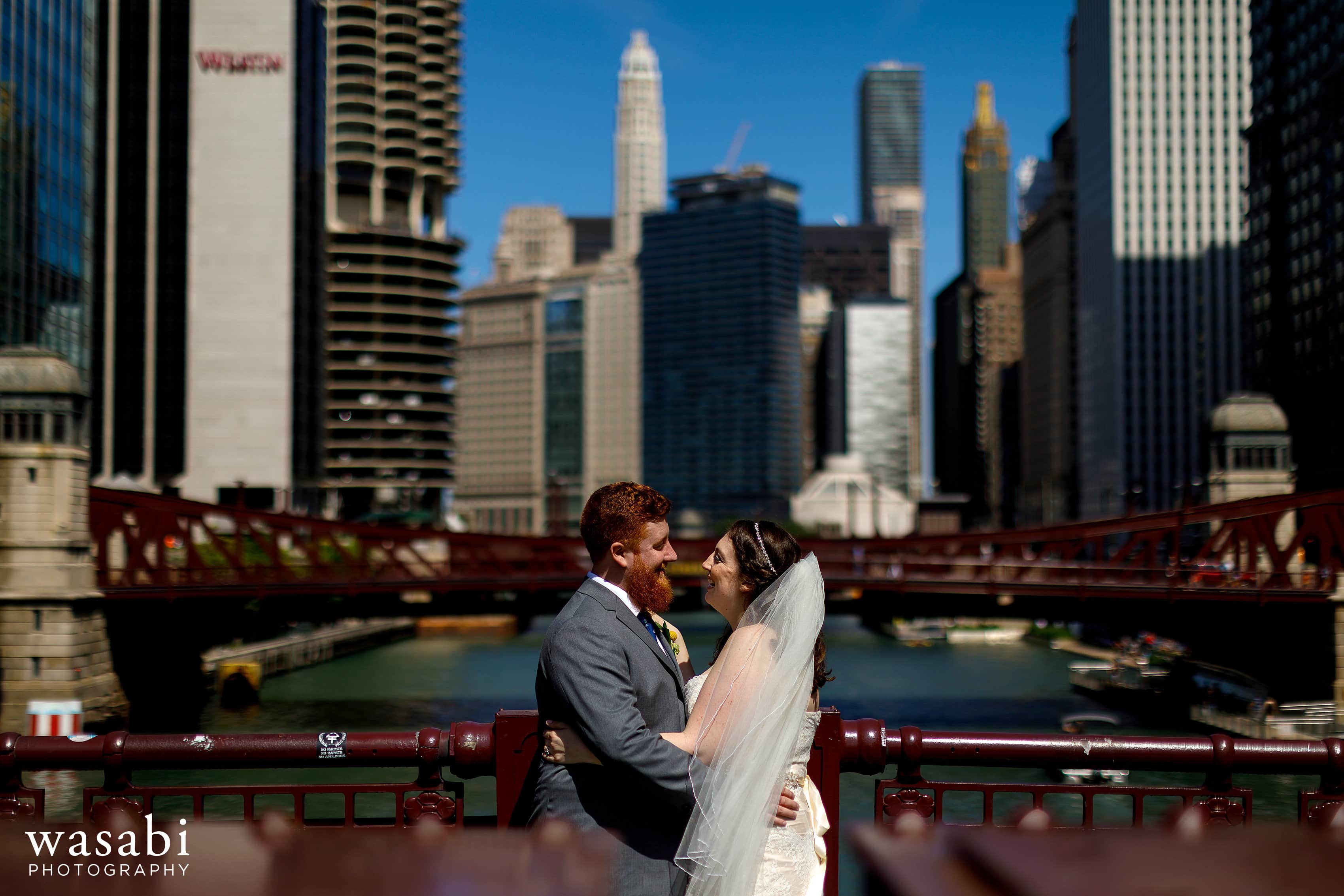 A bride and groom pose for a portrait on the La Salle Street Bridge in Chicago