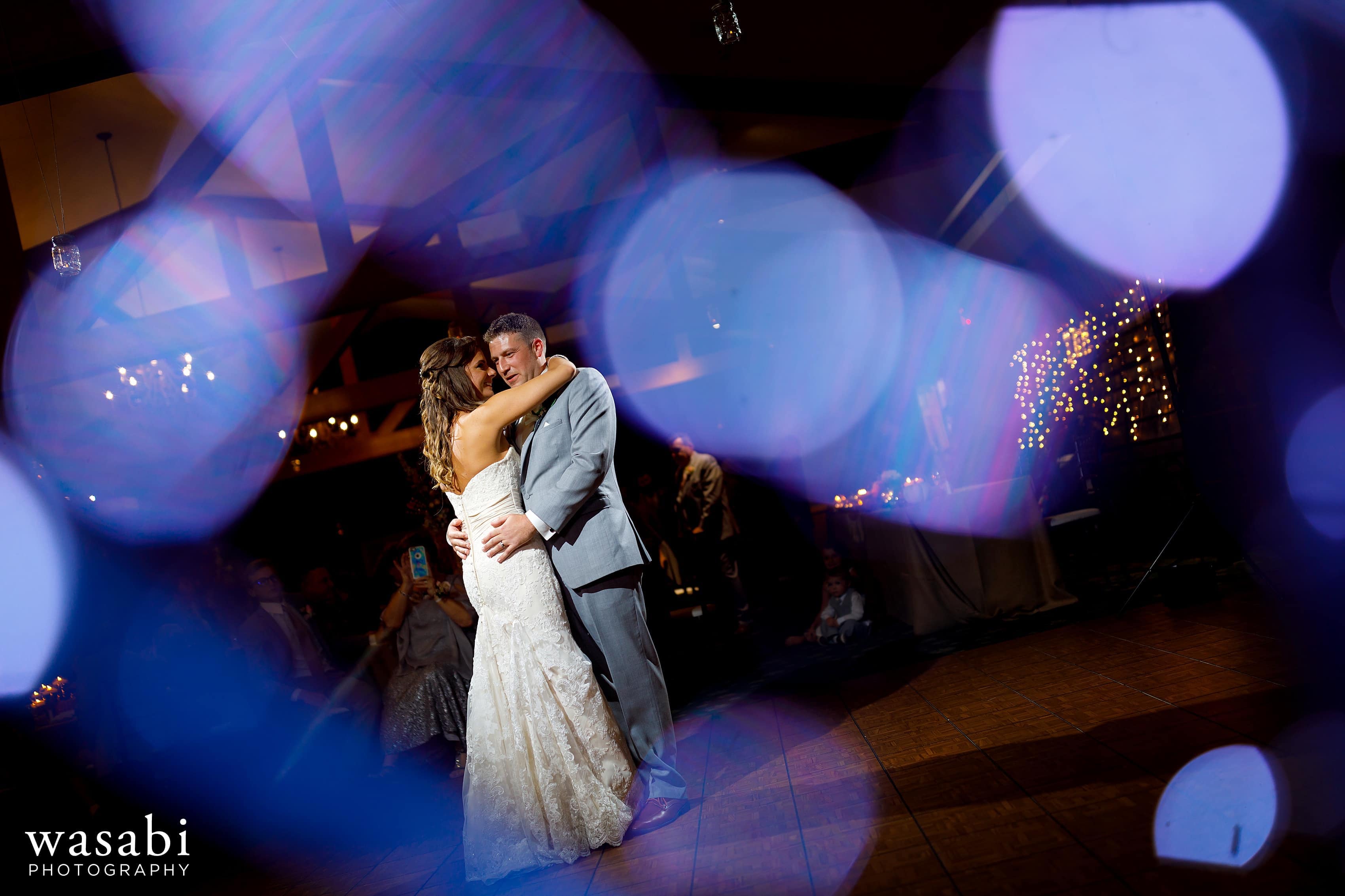 Bride and groom share first dance during Buck's Run Golf Club wedding reception in Mount Pleasant, Michigan.