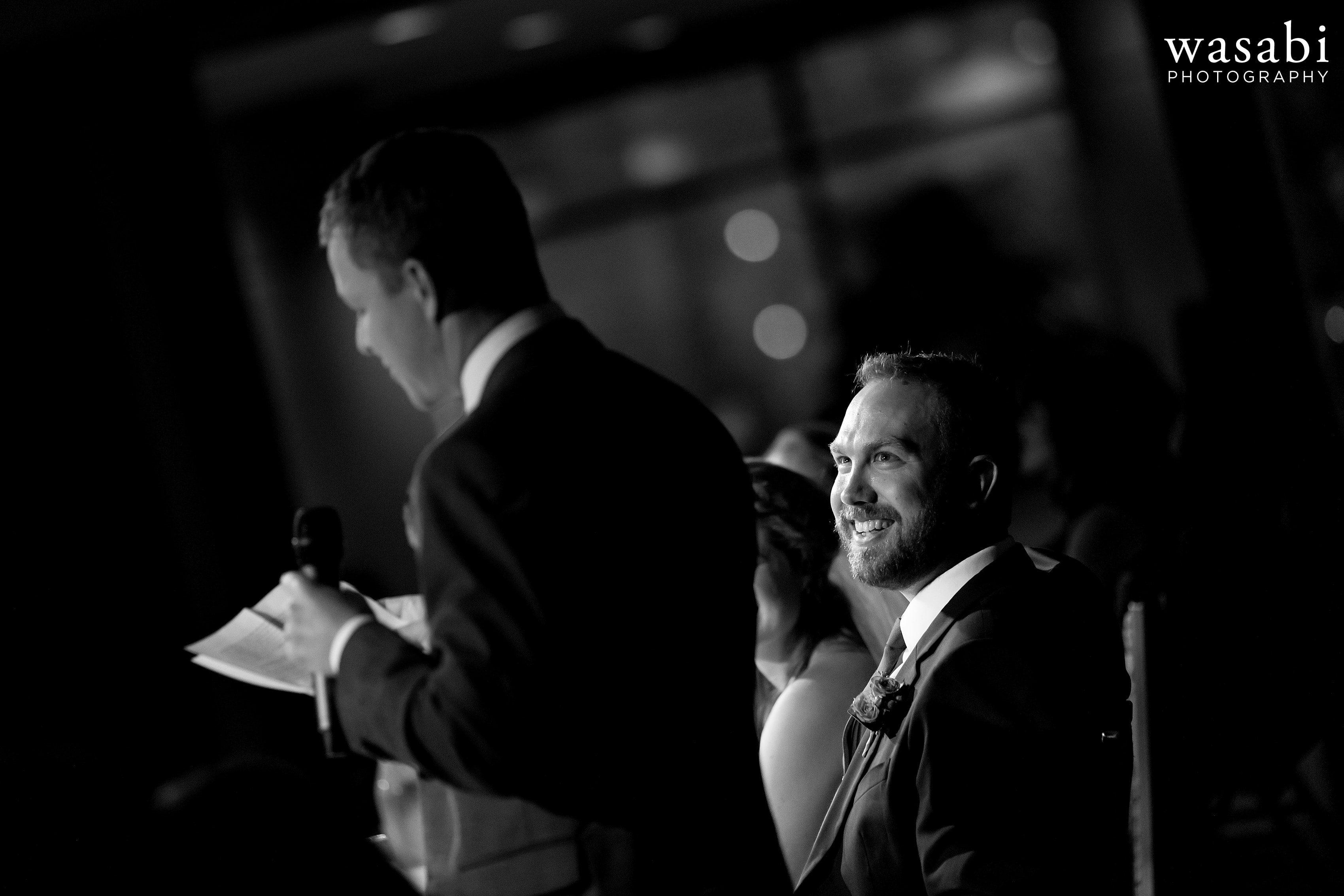 groomsman gives a toast during a wedding reception at Eberhard Center in downtown Grand Rapids