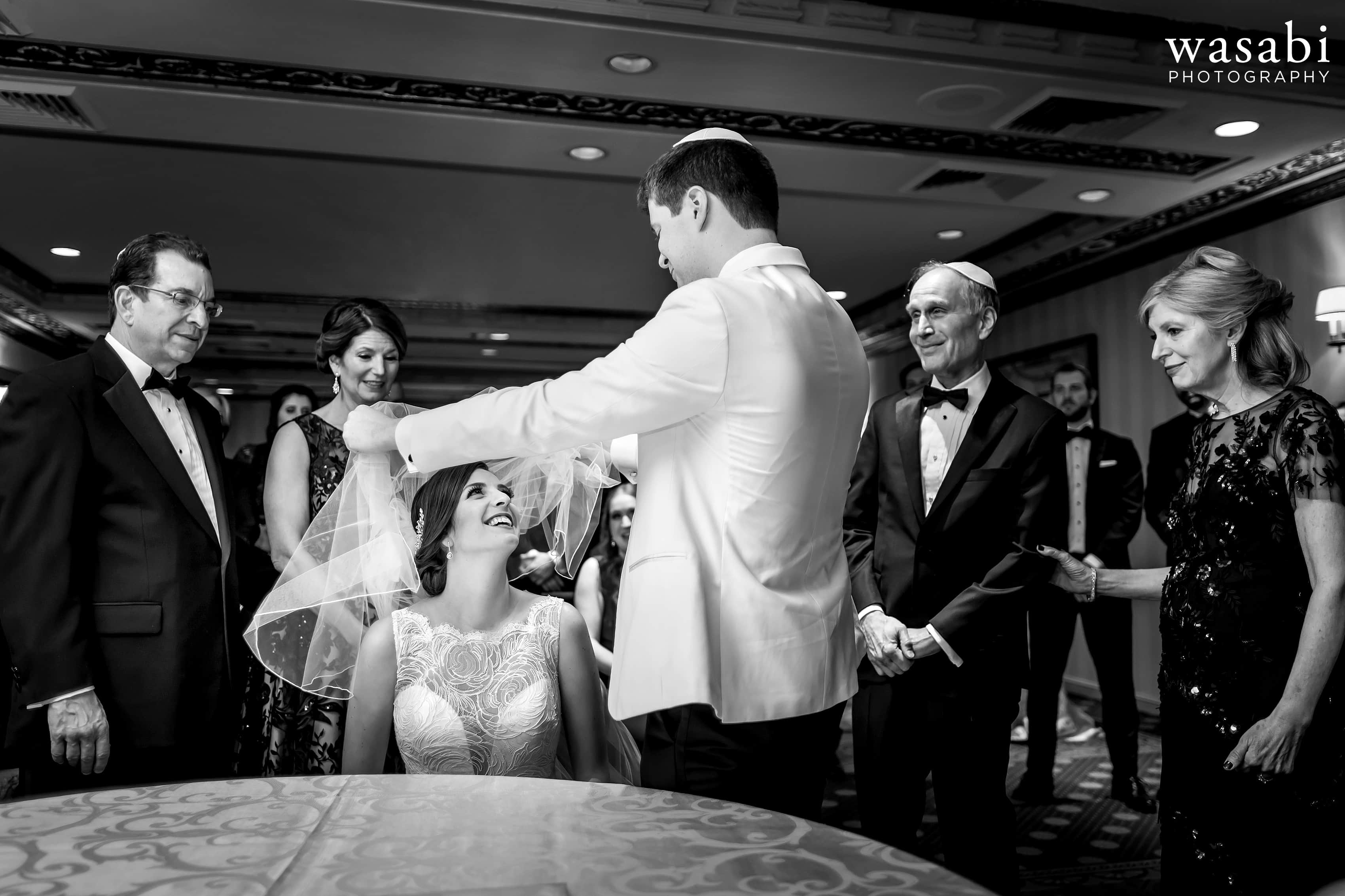 Bride and groom with parents during ketubah ceremony before Jewish wedding at InterContinental Chicago Magnificent Mile Hotel