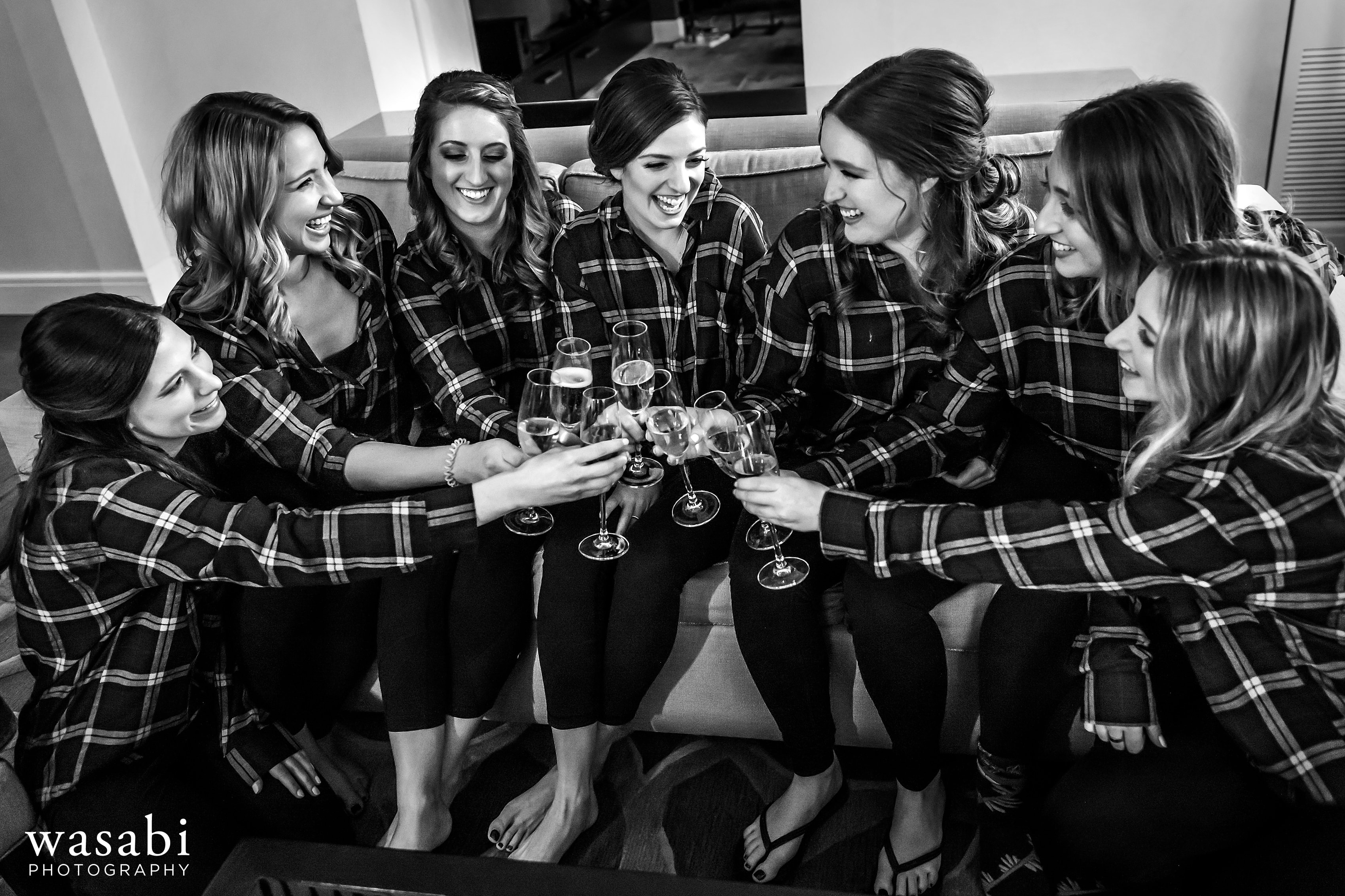 bride and many bridesmaids toast while getting ready for wedding in the presidential suite at  InterContinental Chicago Magnificent Mile Hotel