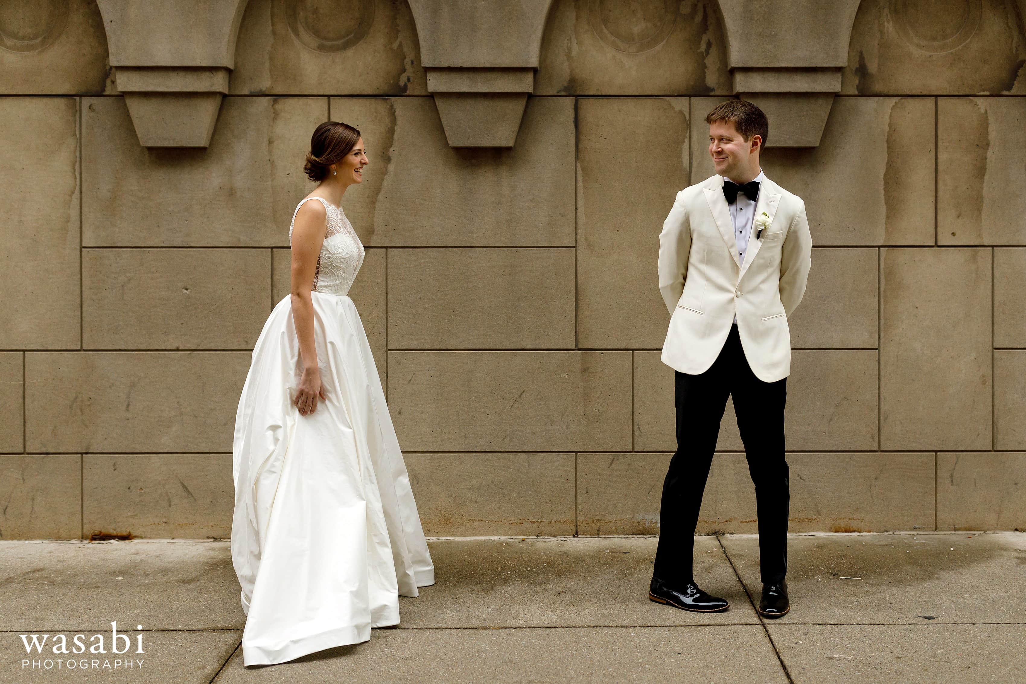 groom reacts to seeing bride during first look outside of InterContinental Chicago Magnificent Mile Hotel