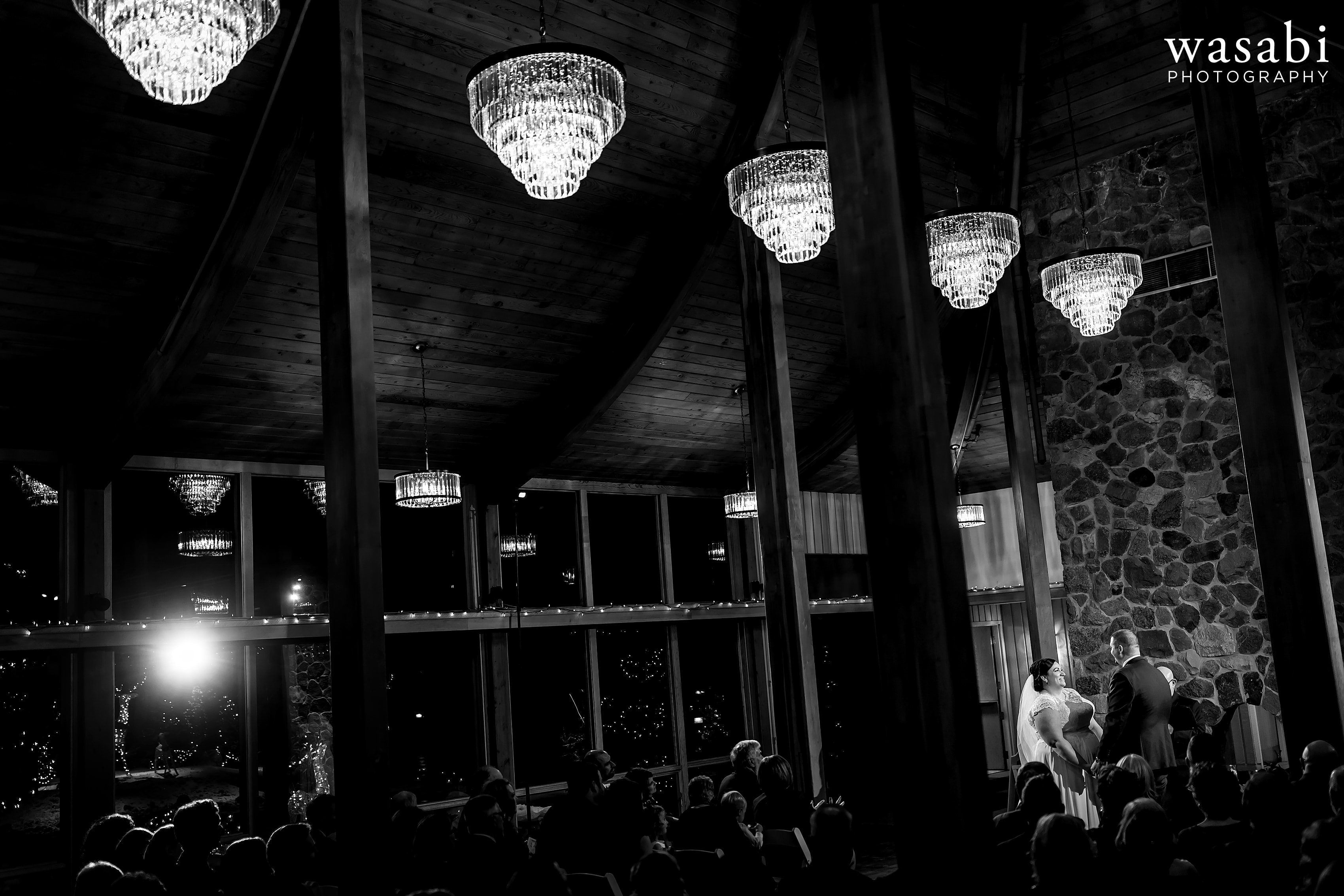 wide angle photo showing venue with bride and groom during Oak Brook Bath and Tennis Club wedding ceremony