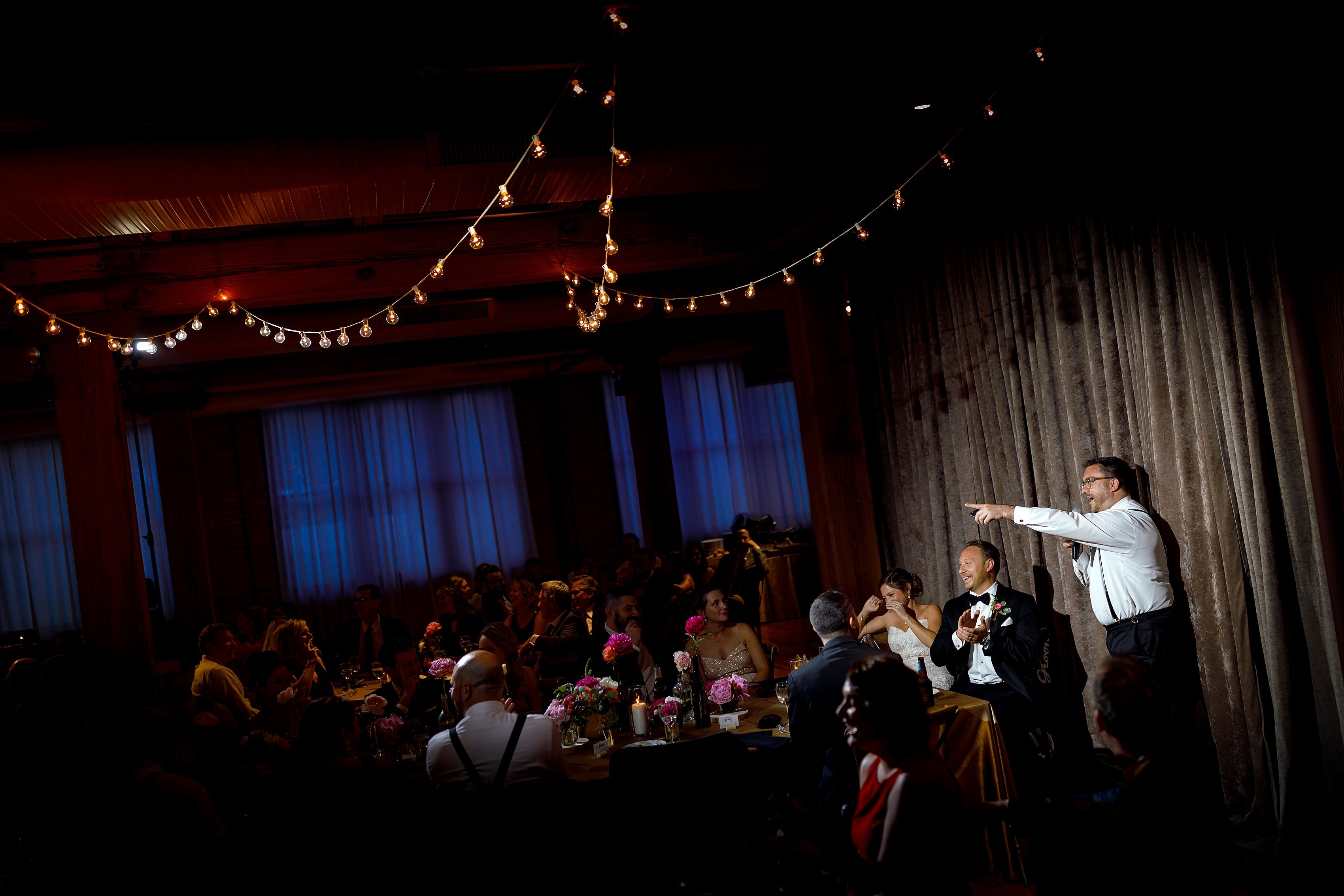 groomsman gives toast during wedding reception at Bridgeport Art Center Sculpture Garden in Chicago