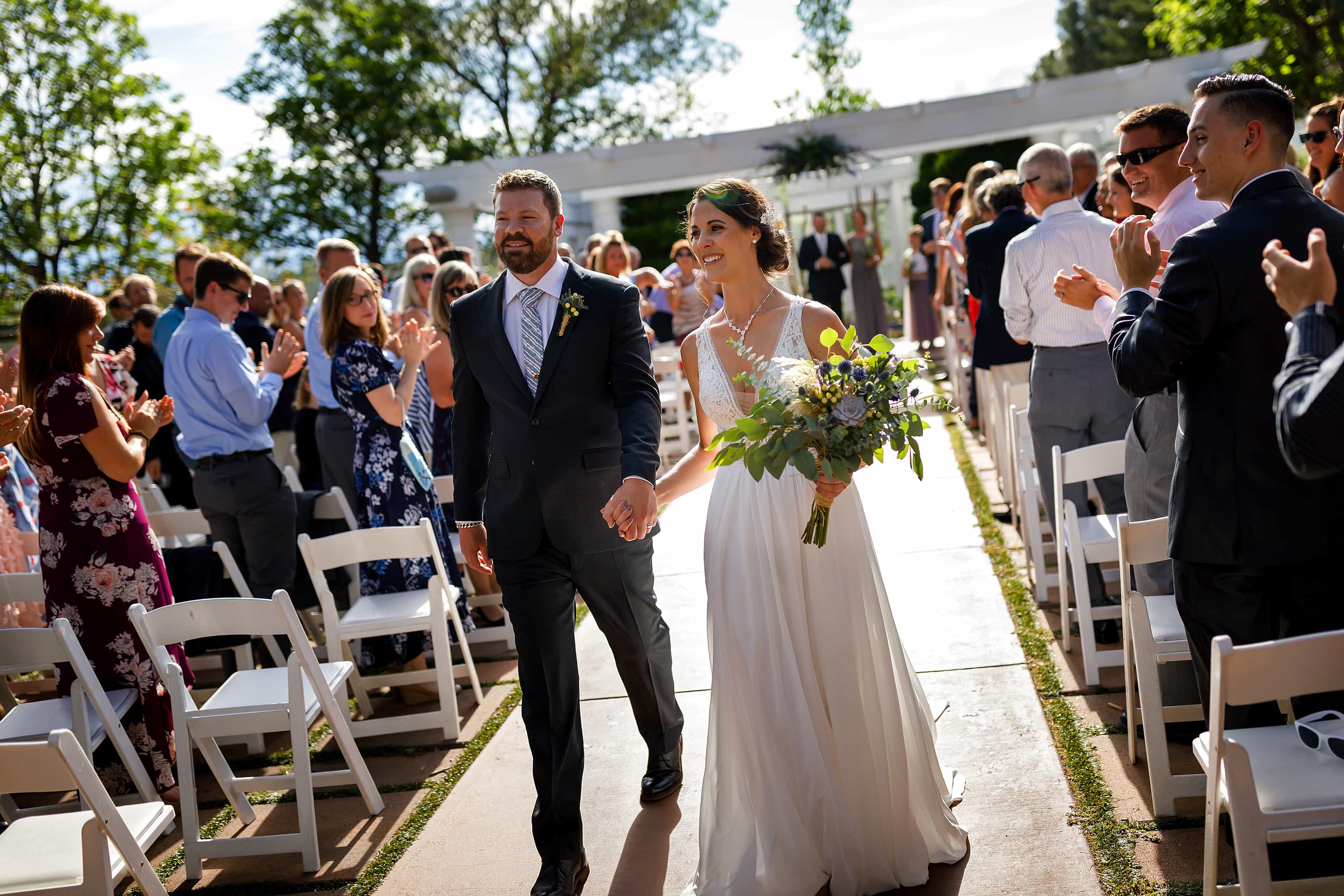 bride and groom walk back down the aisle after outdoor wedding ceremony at Lionsgate Event Center