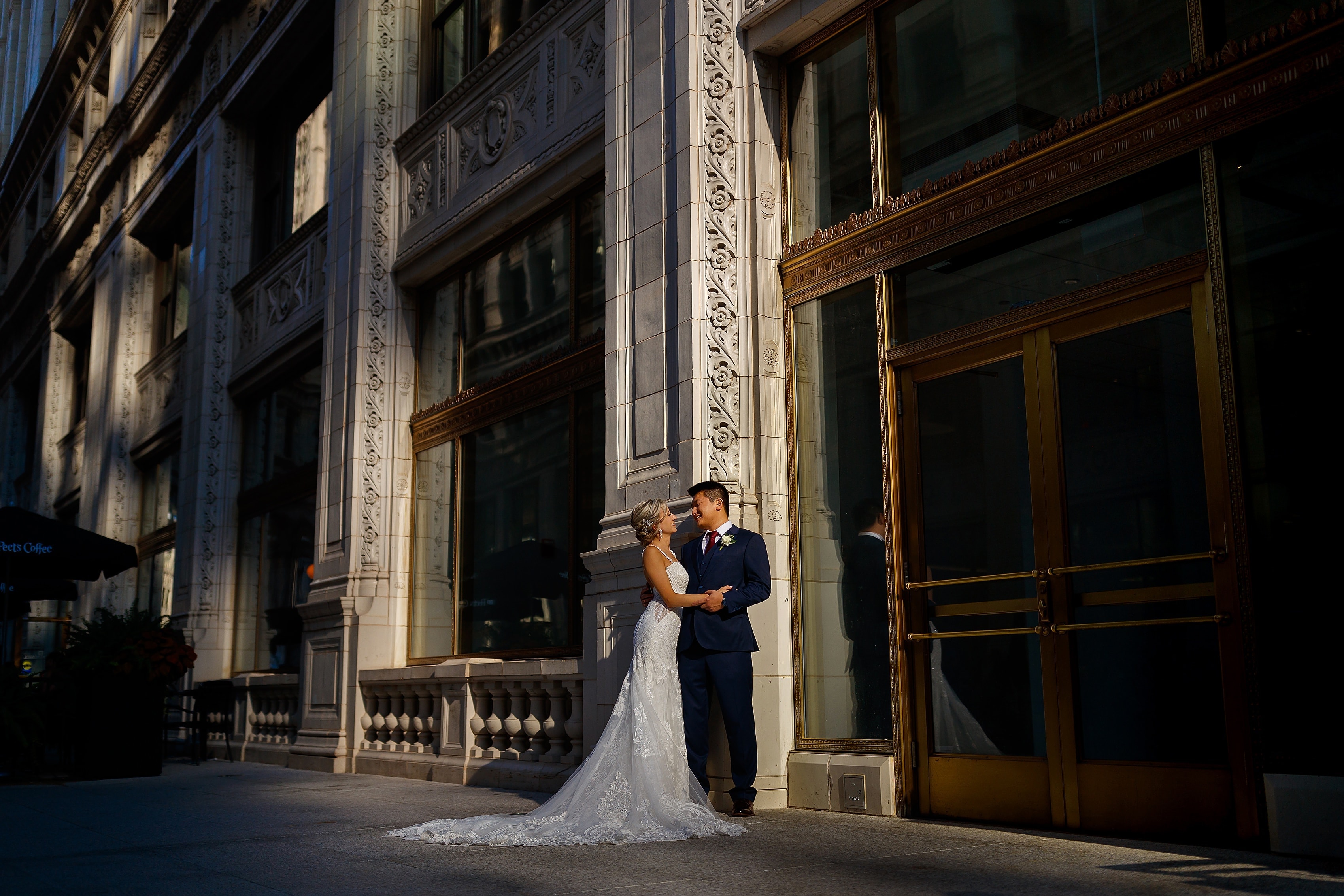 Bride and groom pose for a portrait outside the Wrigley Building in downtown Chicago