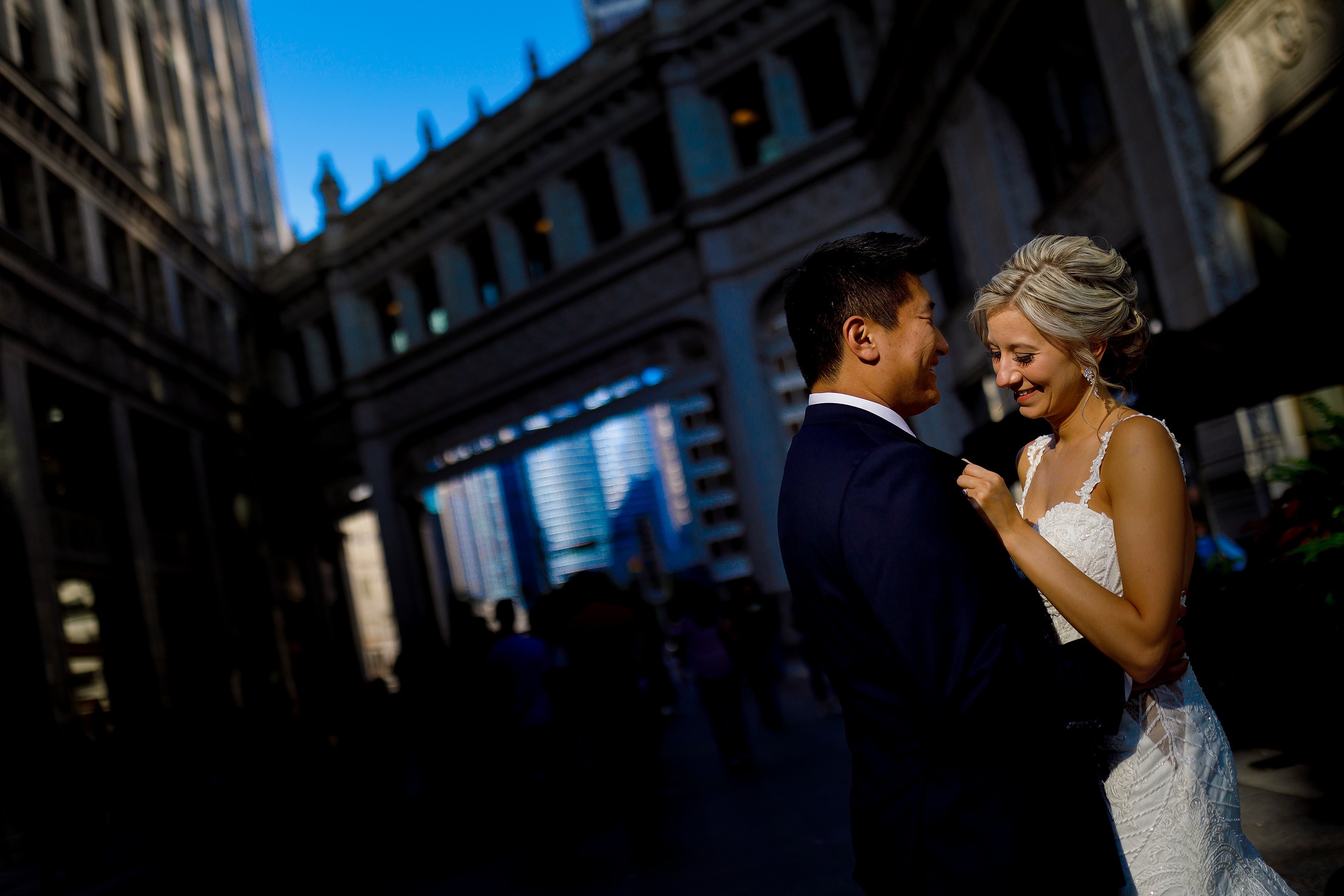 Bride and groom pose for a portrait outside the Wrigley Building in downtown Chicago