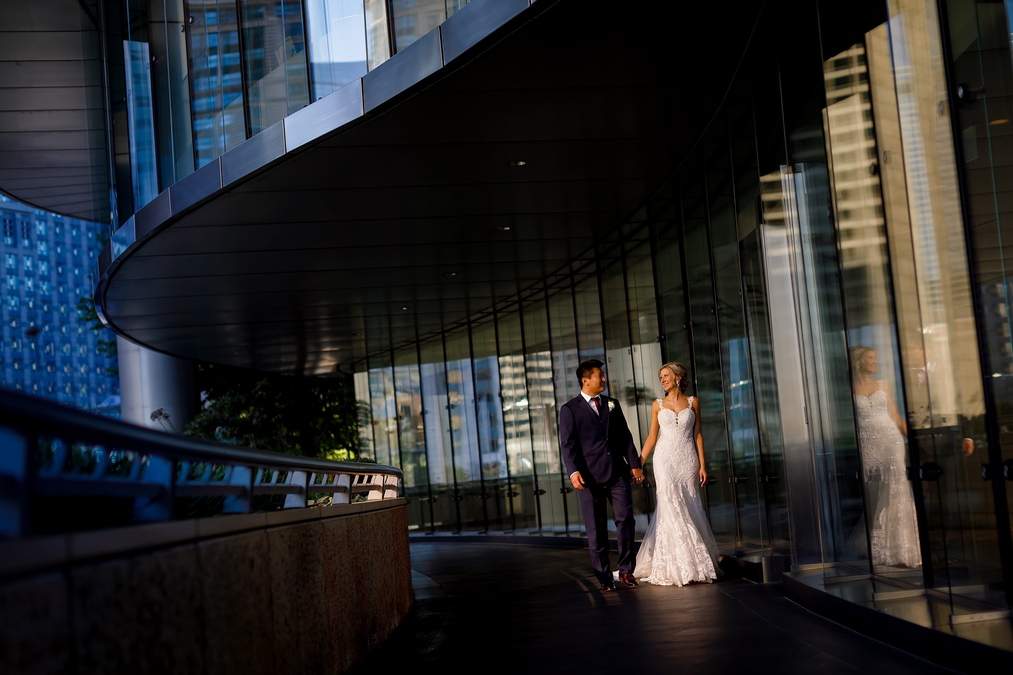 Bride and groom walk along the Chicago Riverwalk in downtown Chicago