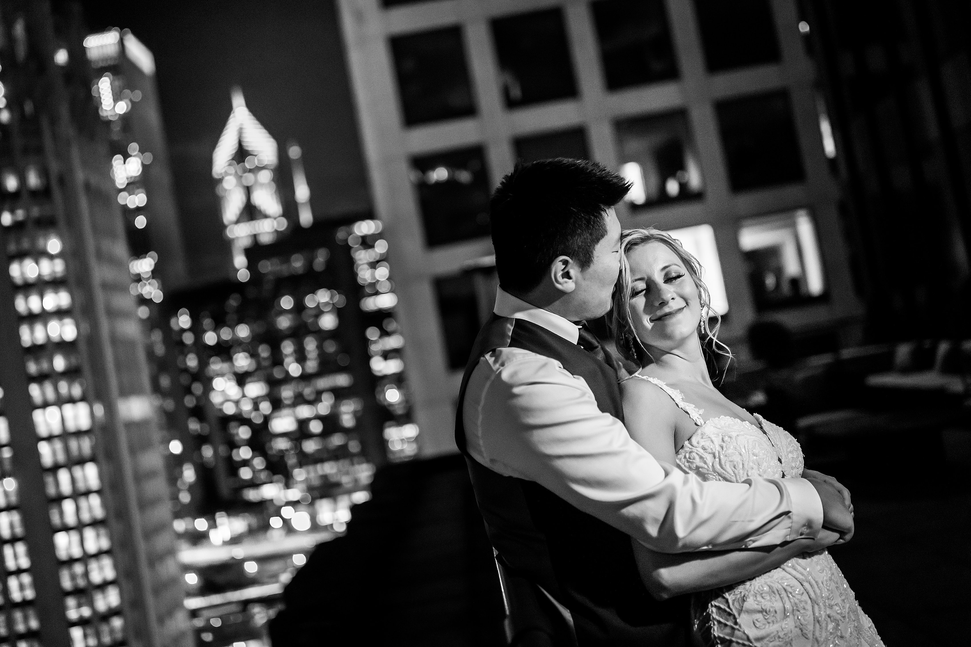 Bride and groom pose for a night portrait on the patio rooftop of the Lux Suite at The Gwen Hotel in downtown Chicago
