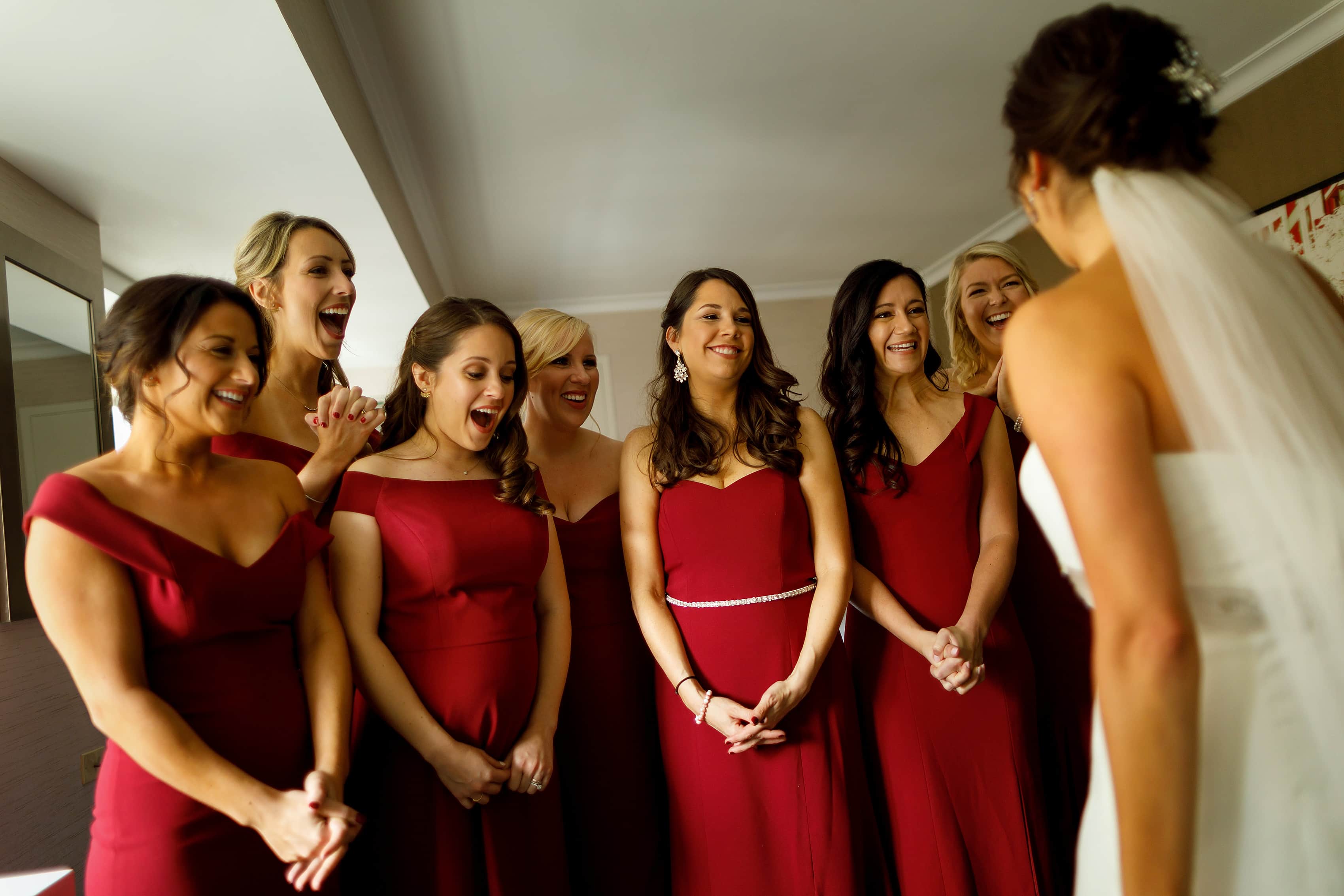 bridesmaids react to seeing bride in her dress while getting ready at The Westin Michigan Ave for wedding at Holy Name Cathedral