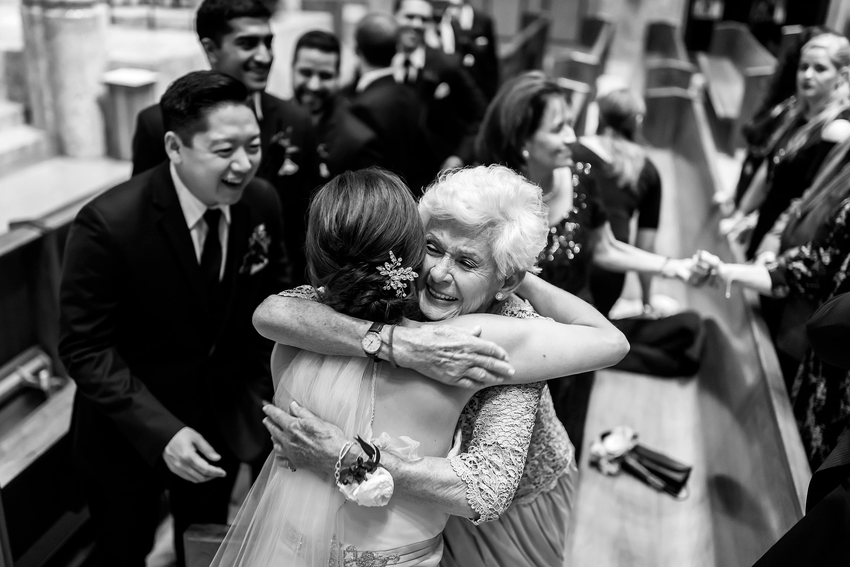 bride hugs grandmother during wedding at Holy Name Cathedral in downtown Chicago