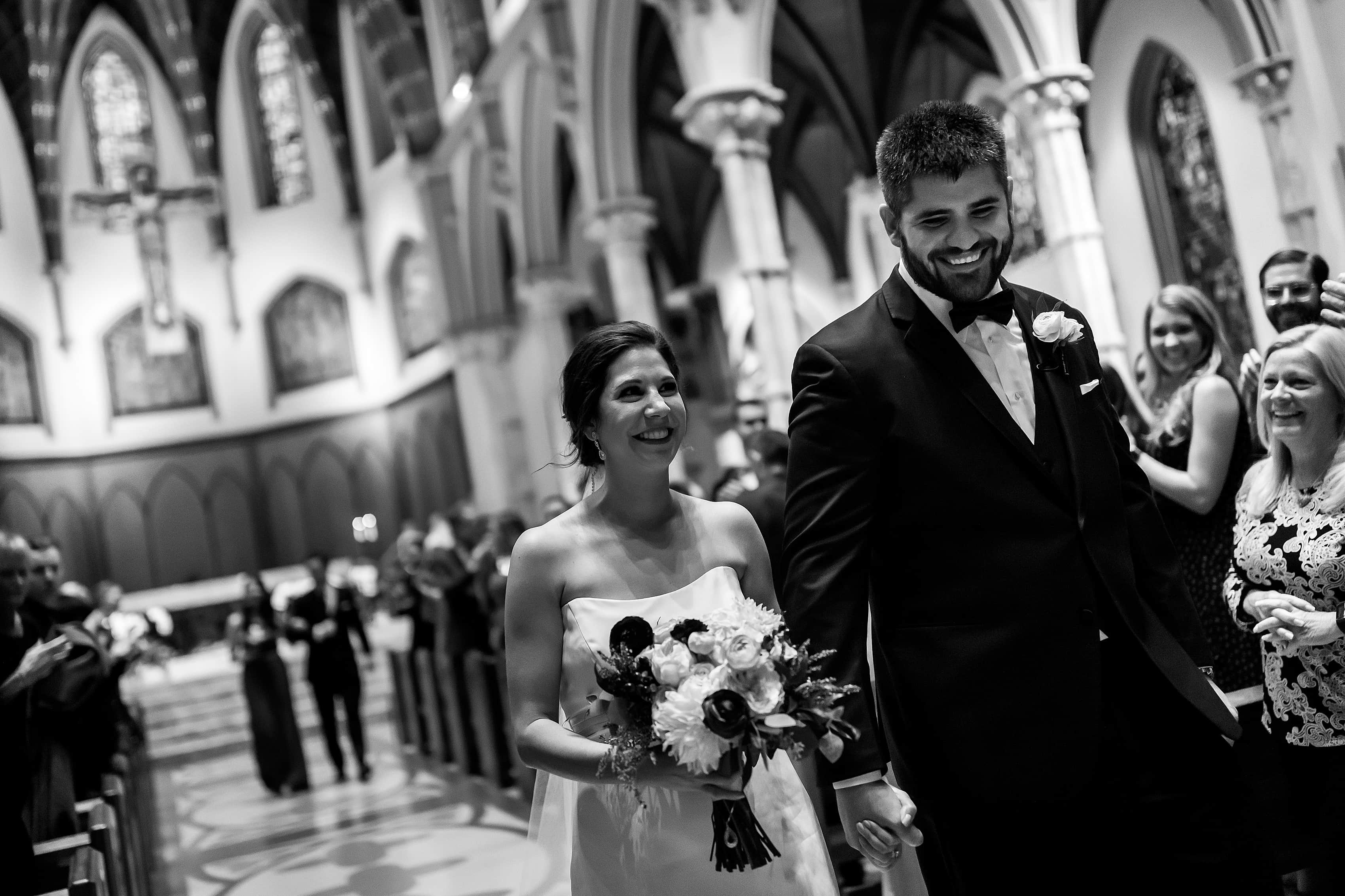 bride and groom walk down the aisle after ceremony at Holy Name Cathedral in downtown Chicago