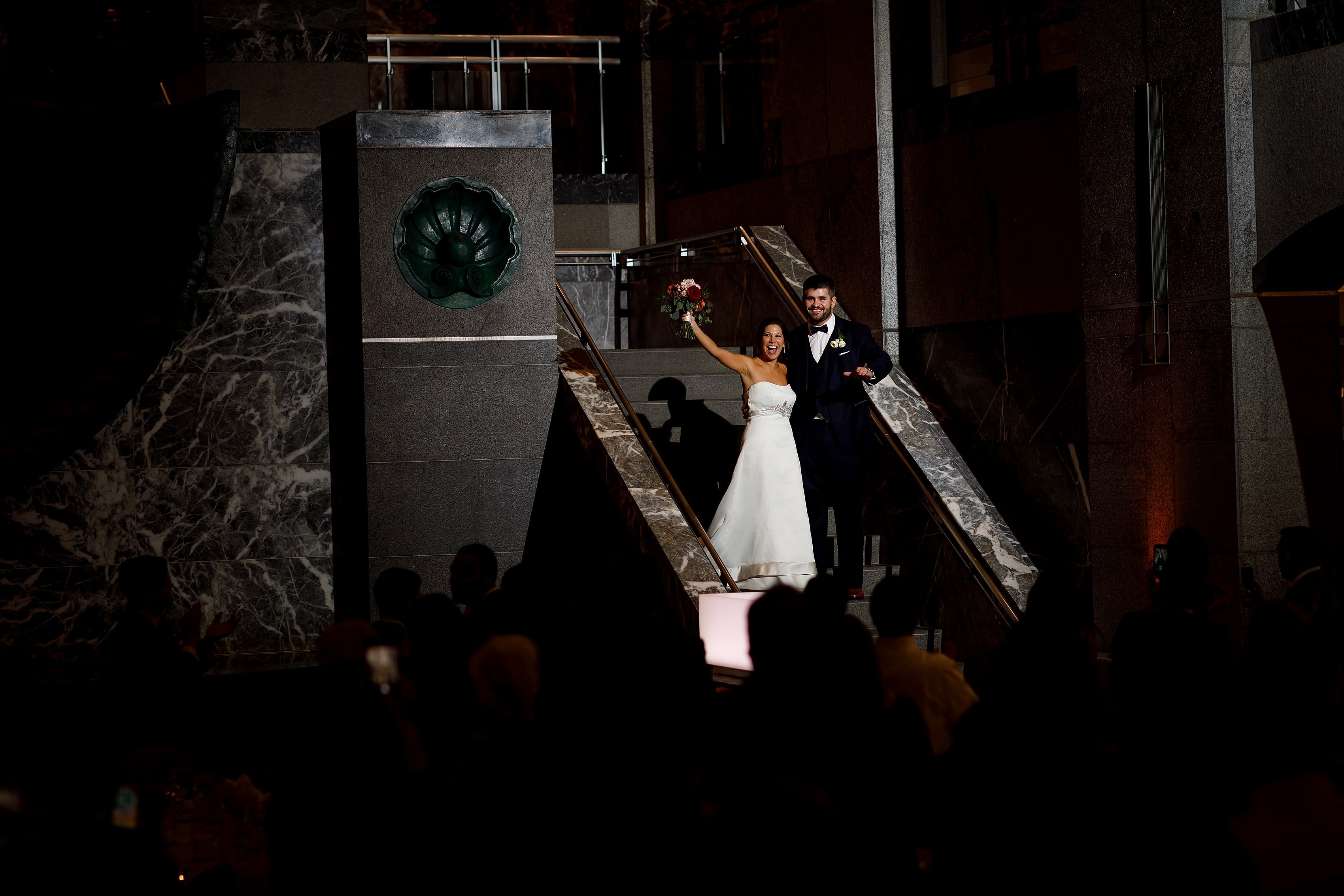 bride and groom walk down the stairs during grand entrance into wedding reception at Pazzo's at Three-Eleven in downtown Chicago