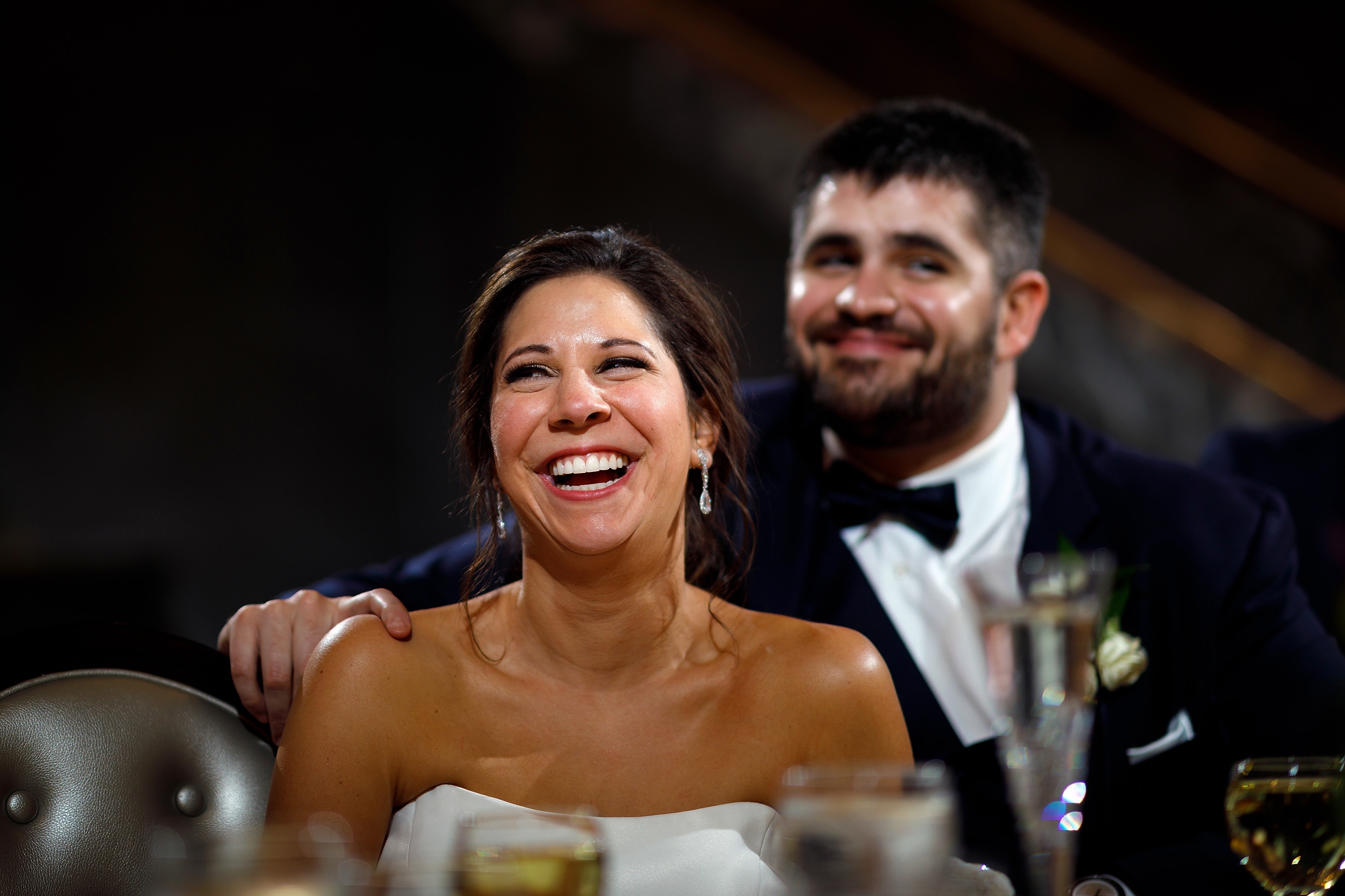 bride and groom laugh during toasts at wedding reception at Pazzo's at Three-Eleven in downtown Chicago