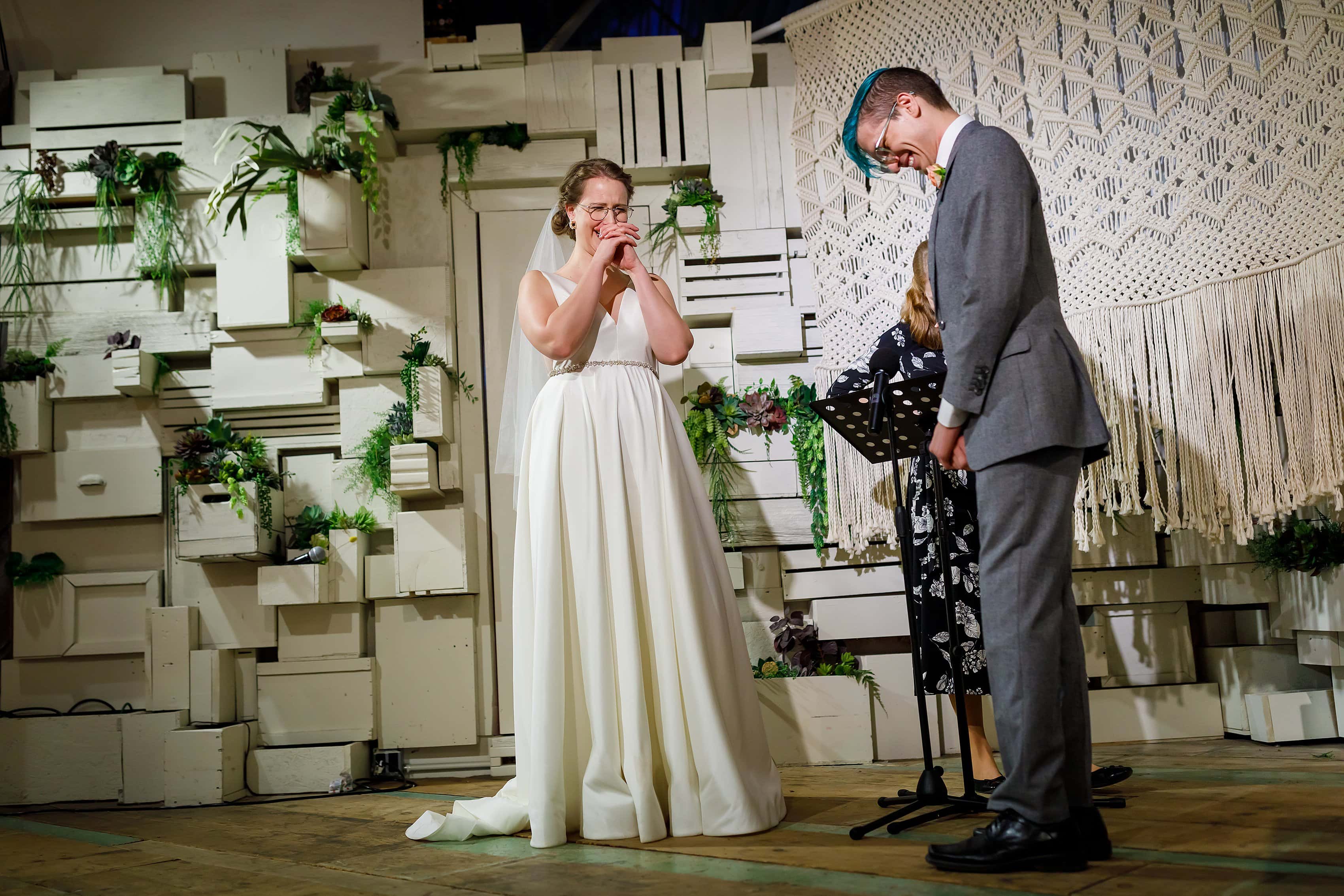bride and groom on stage during wedding ceremony at Rust Belt Market in downtown Ferndale, Michigan