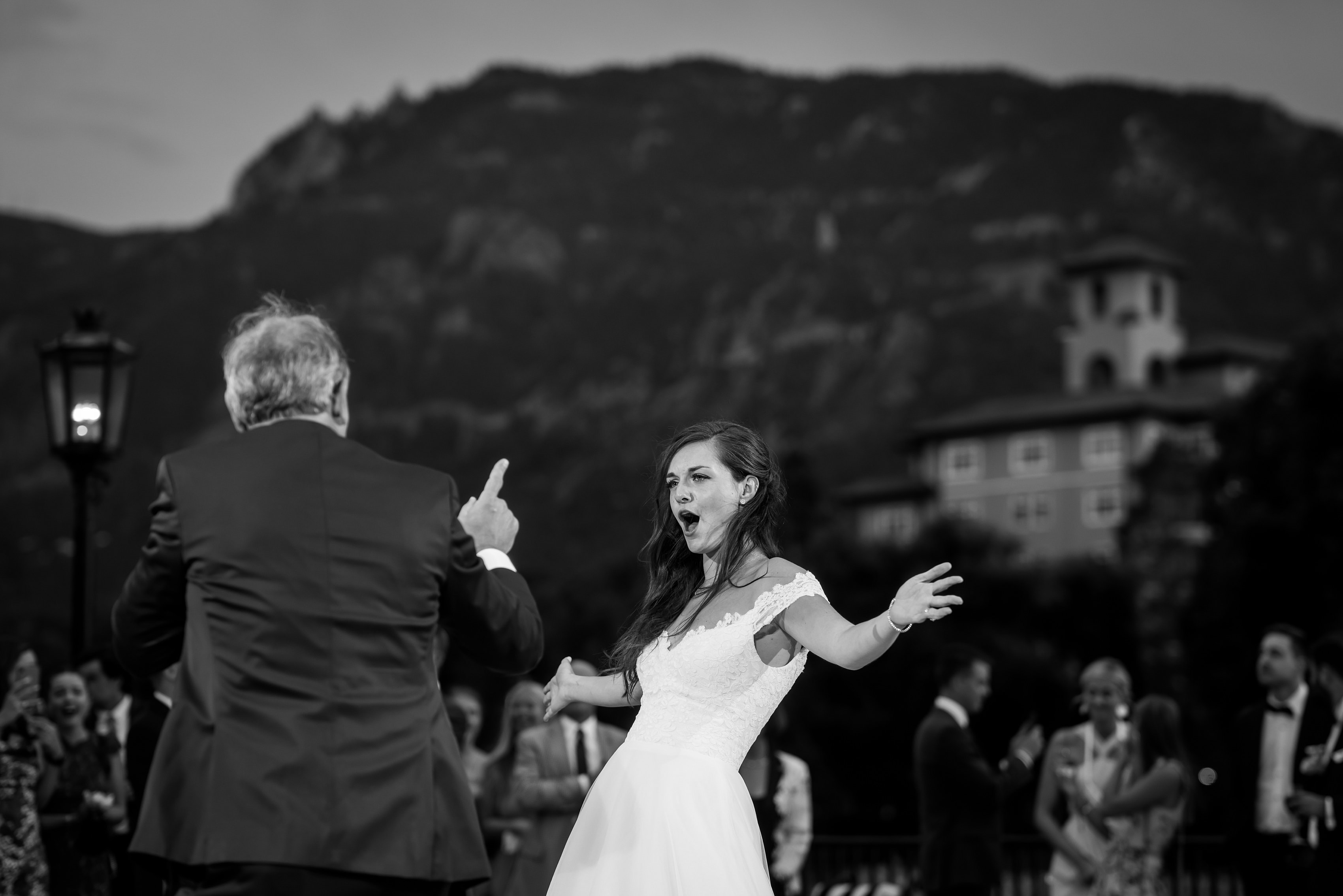 bride shares first dance with her father outdoors on the patio during wedding reception at The Broadmoor Hotel
