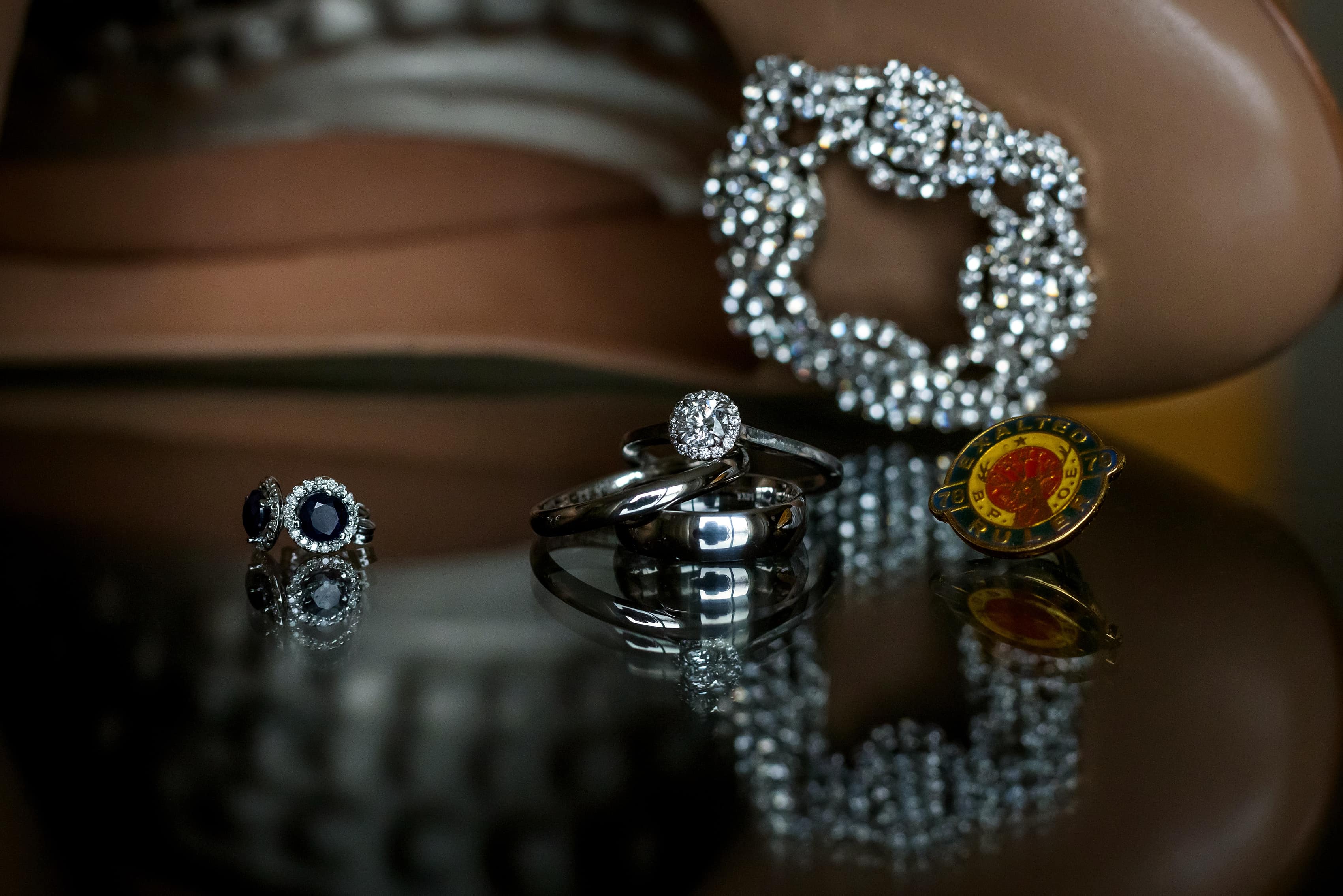 closeup of wedding ring, earrings and shoe