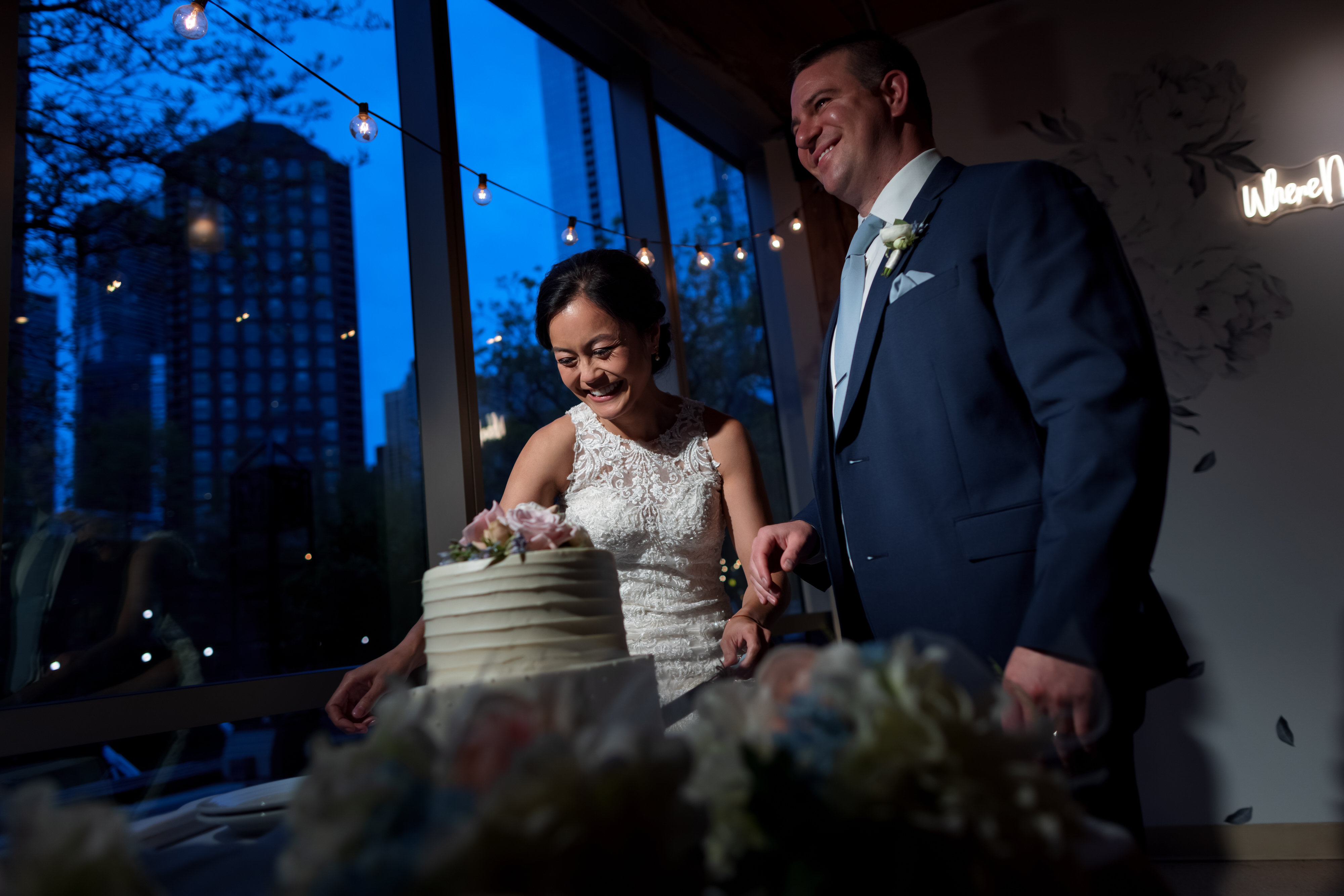 bride and groom cut cake during wedding reception at Pinstripes Chicago
