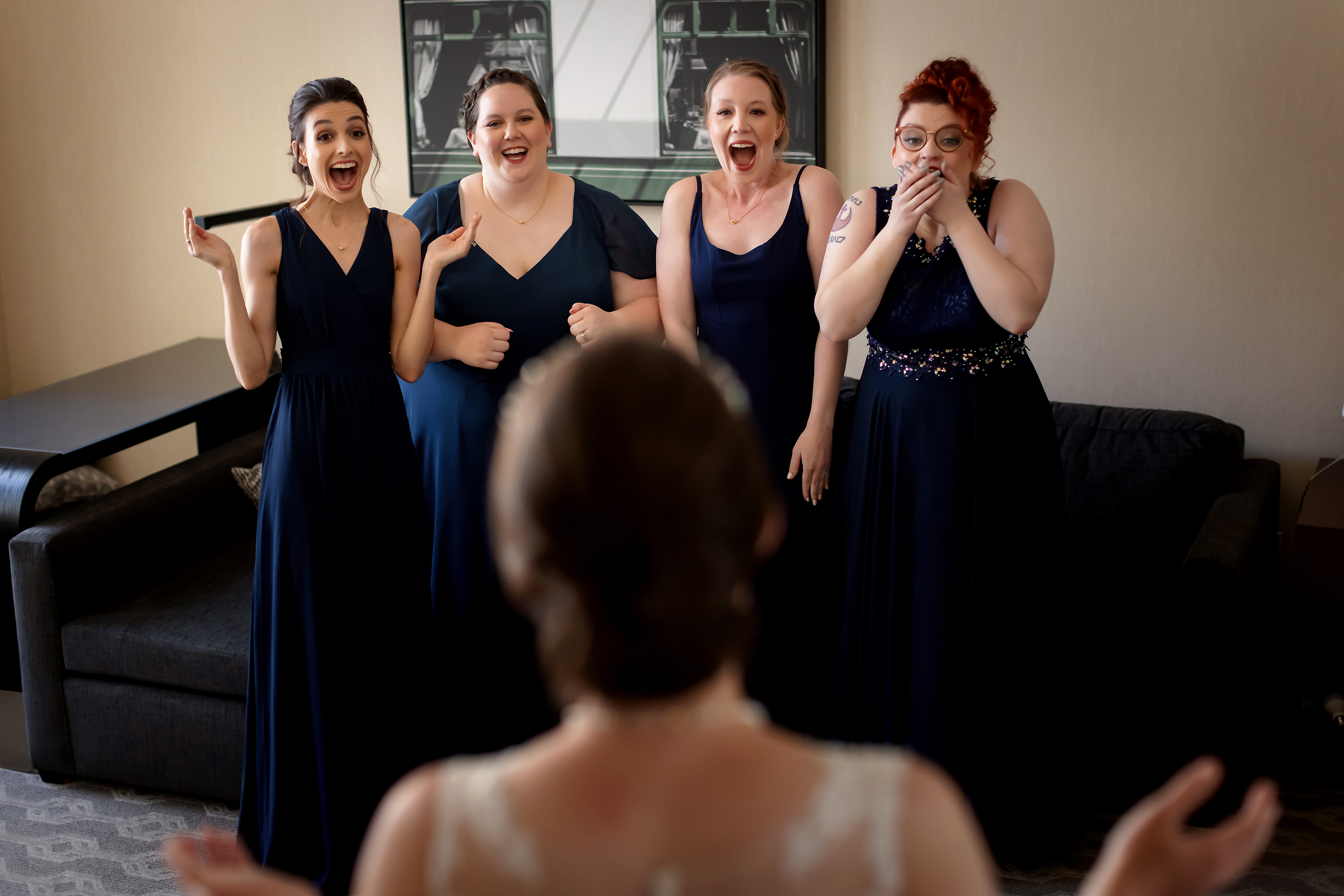Bridesmaids react to seeing bride in her dress