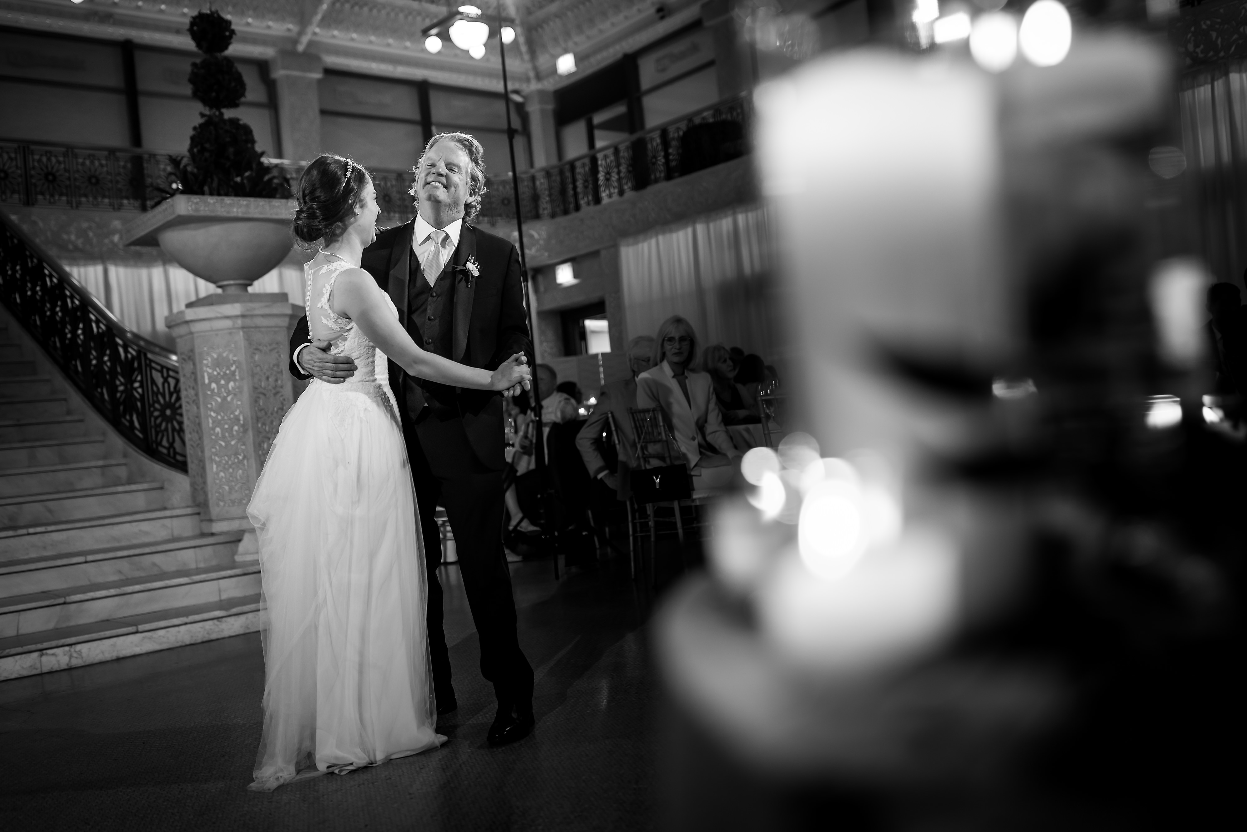 Father of the bride dances with daughter during wedding reception at the Rookery Building in Chicago