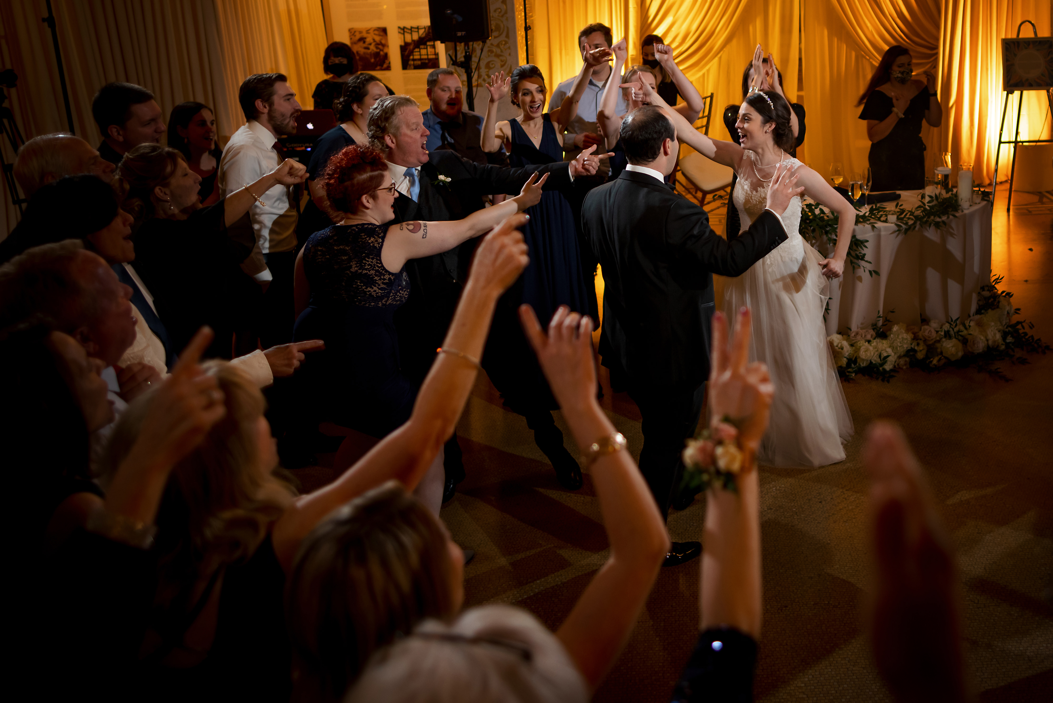 Wedding guests dance with couple during wedding reception at the Rookery Building in Chicago