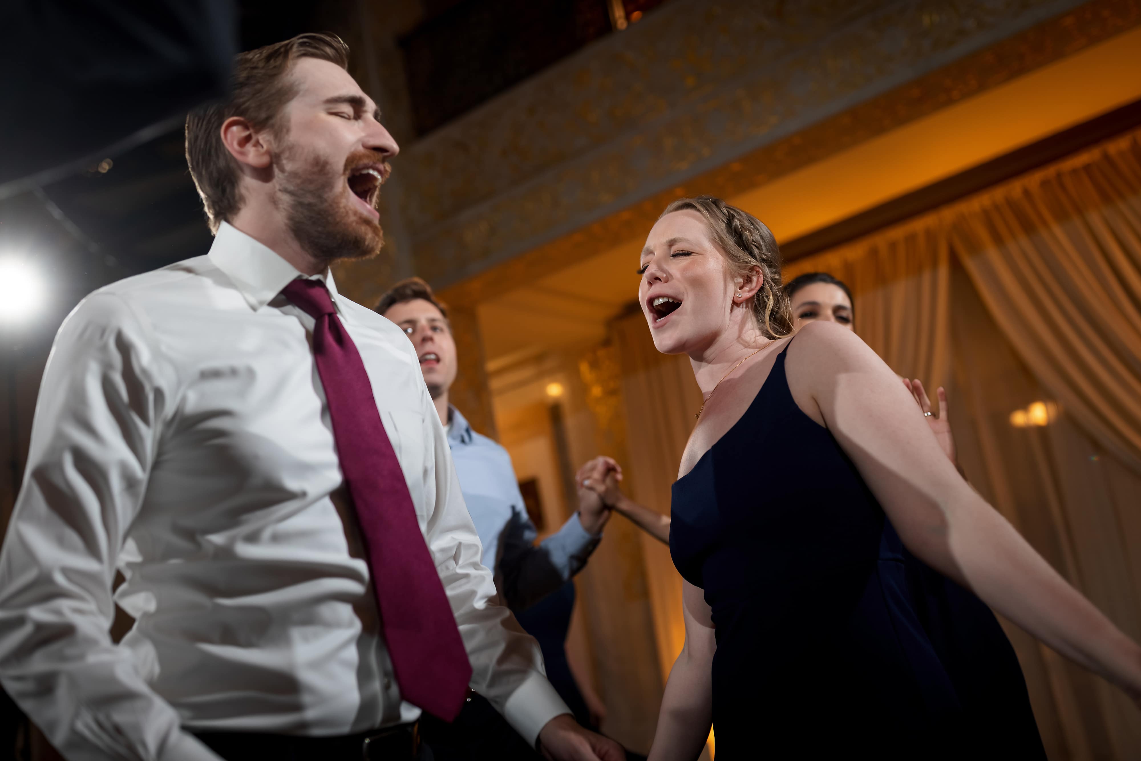 Wedding guests dance during reception at the Rookery Building in Chicago