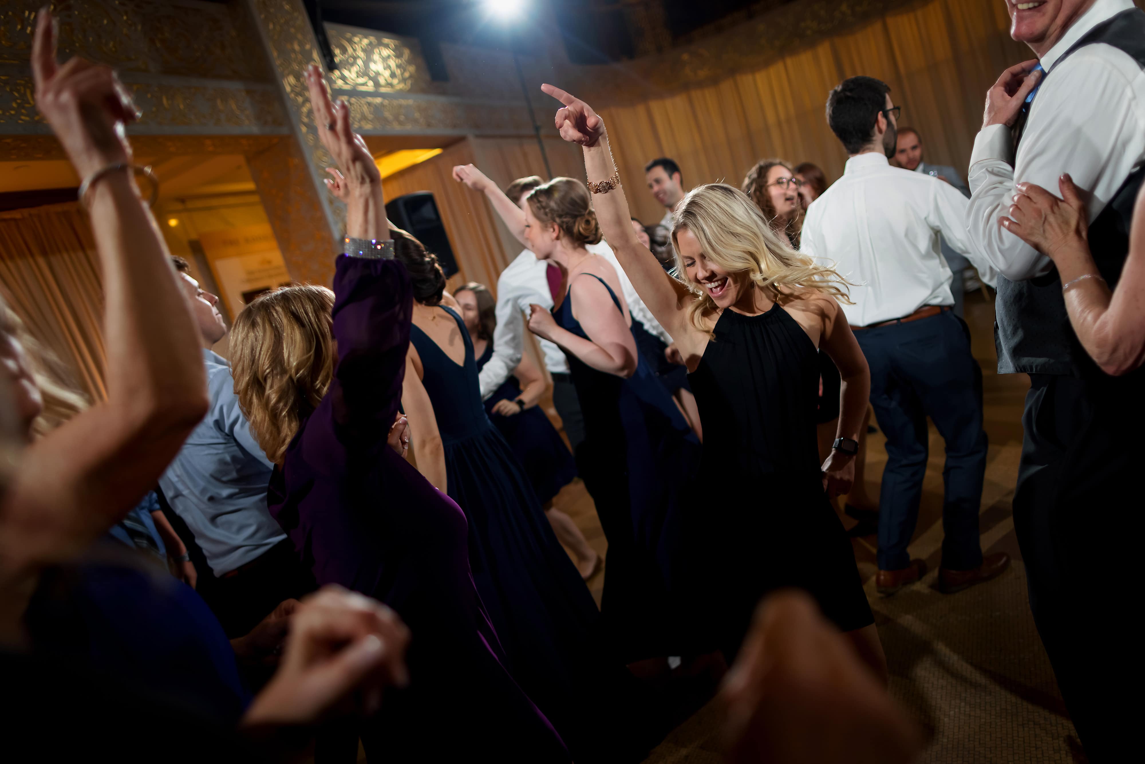 Wedding guests dance during reception at the Rookery Building in Chicago