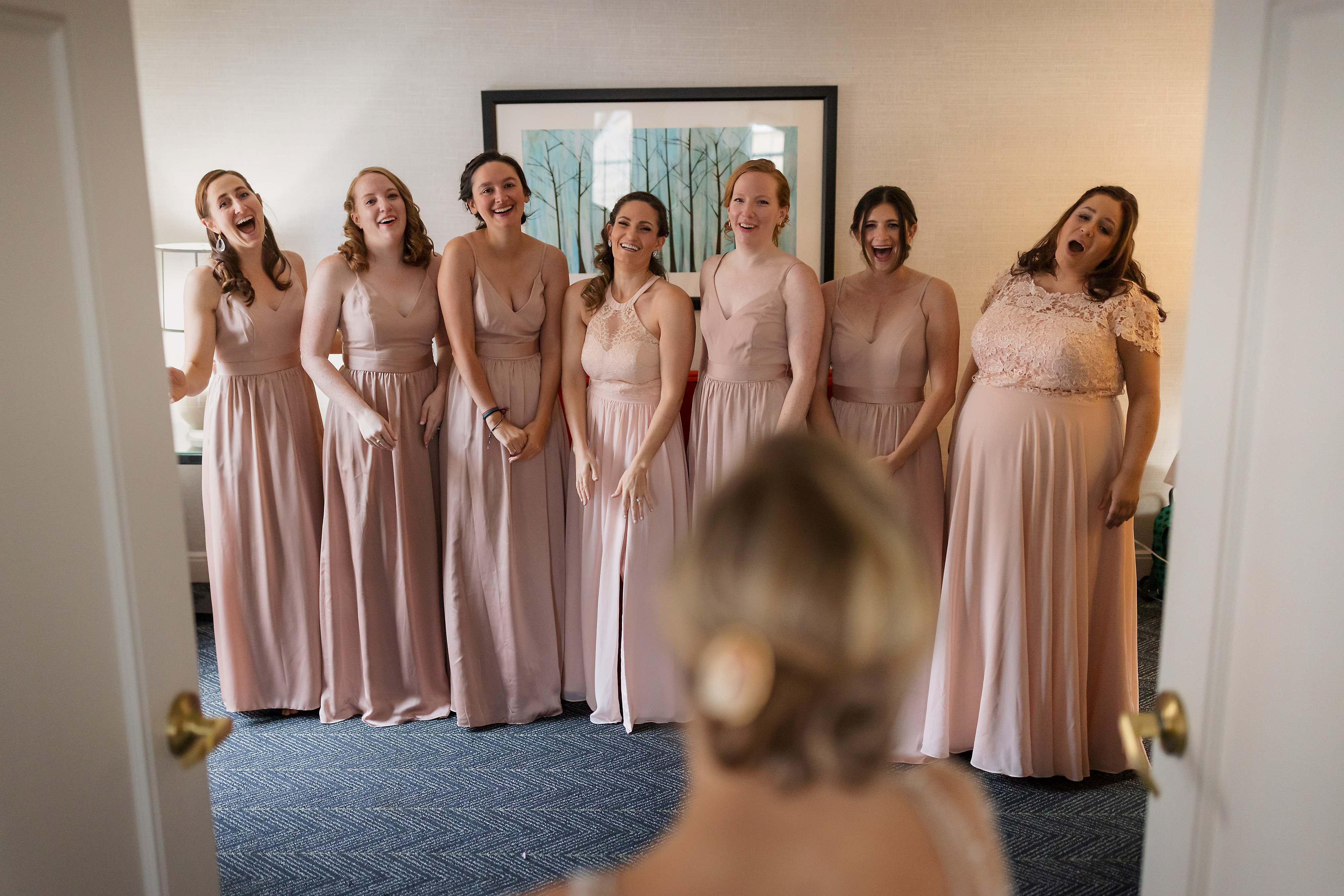 bridesmaids react to bride in her dress