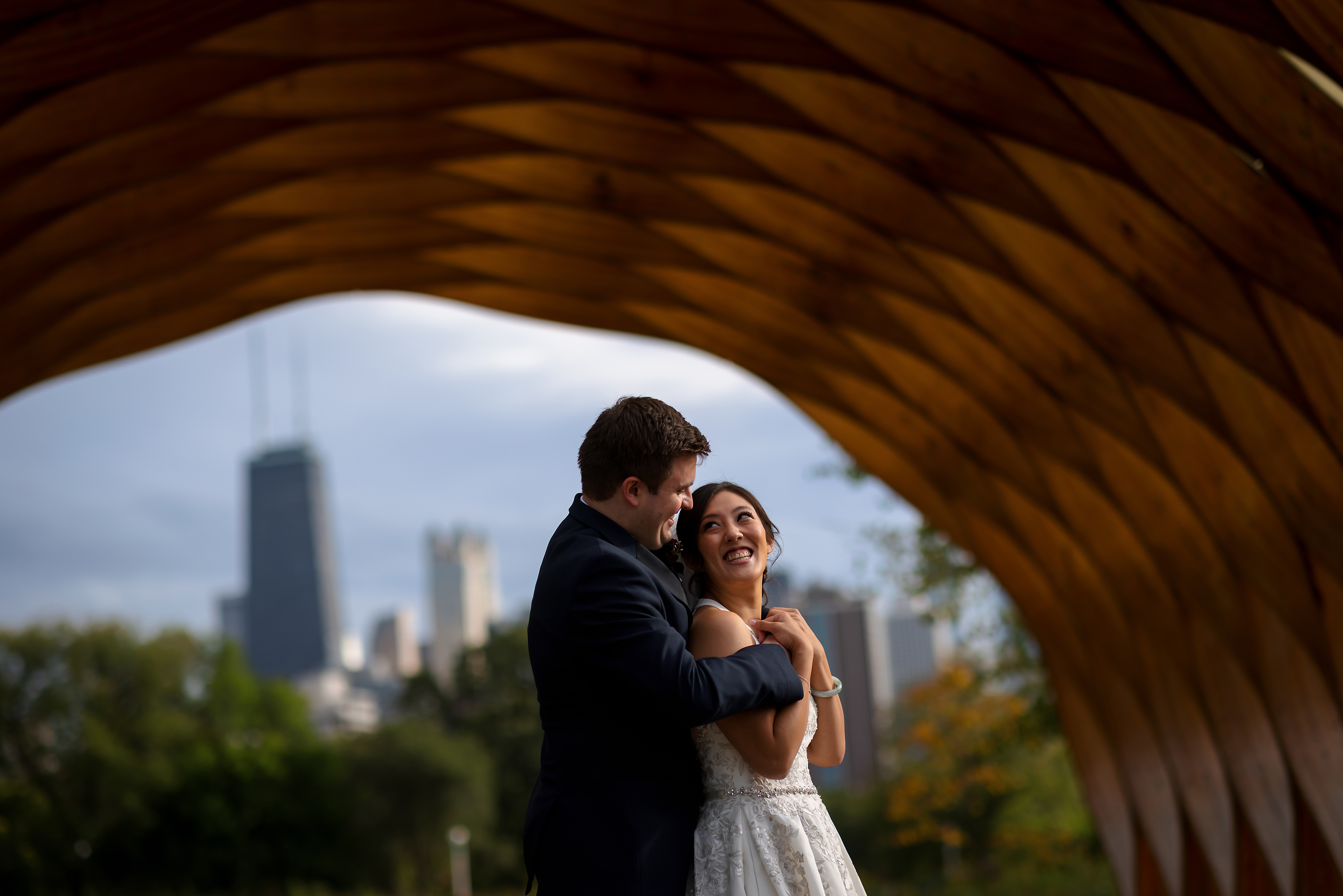 bride and groom under wooden arch honeycomb at Lincoln Park