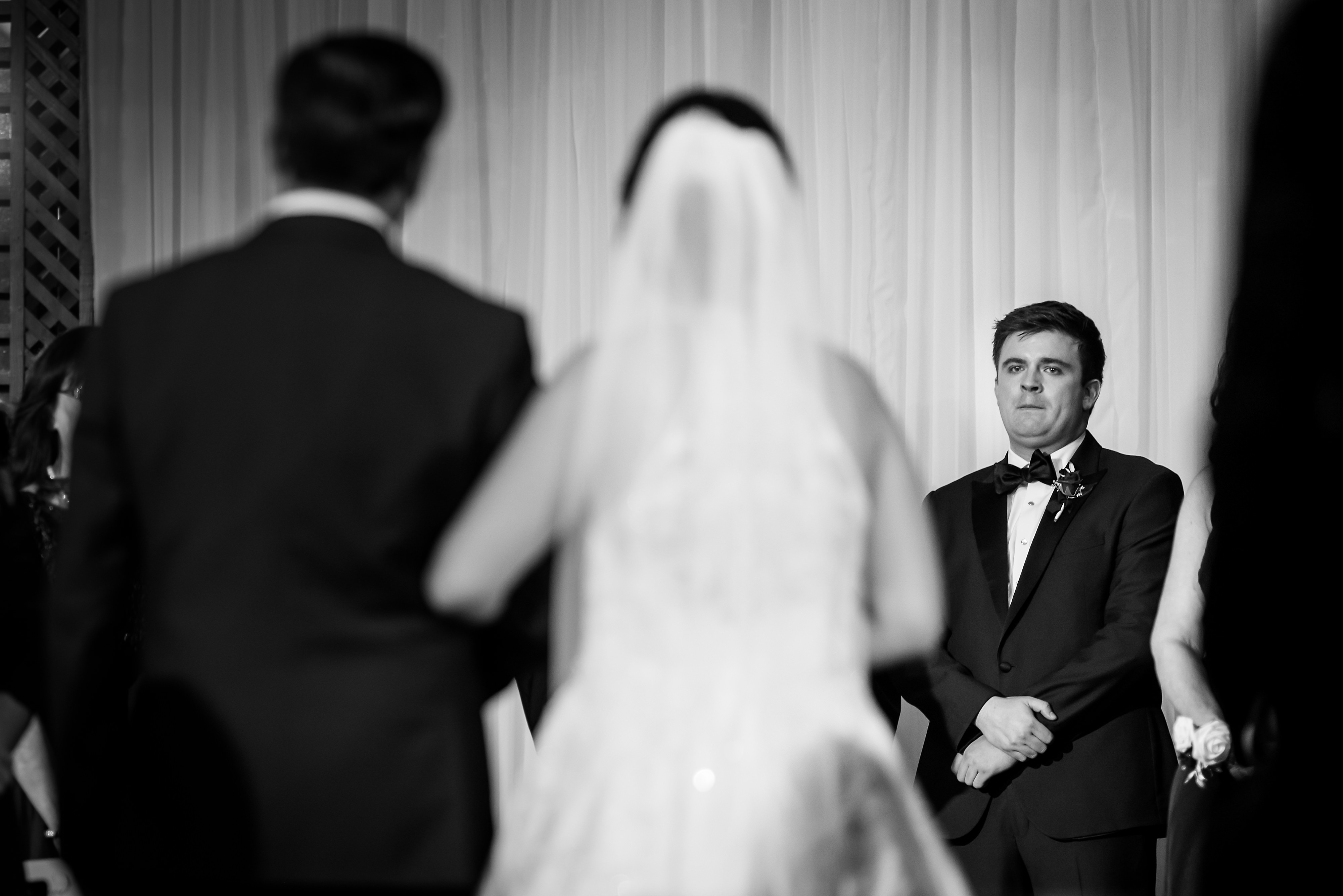 groom reacts while bride and father walk down the aisle during wedding at Salvatore's