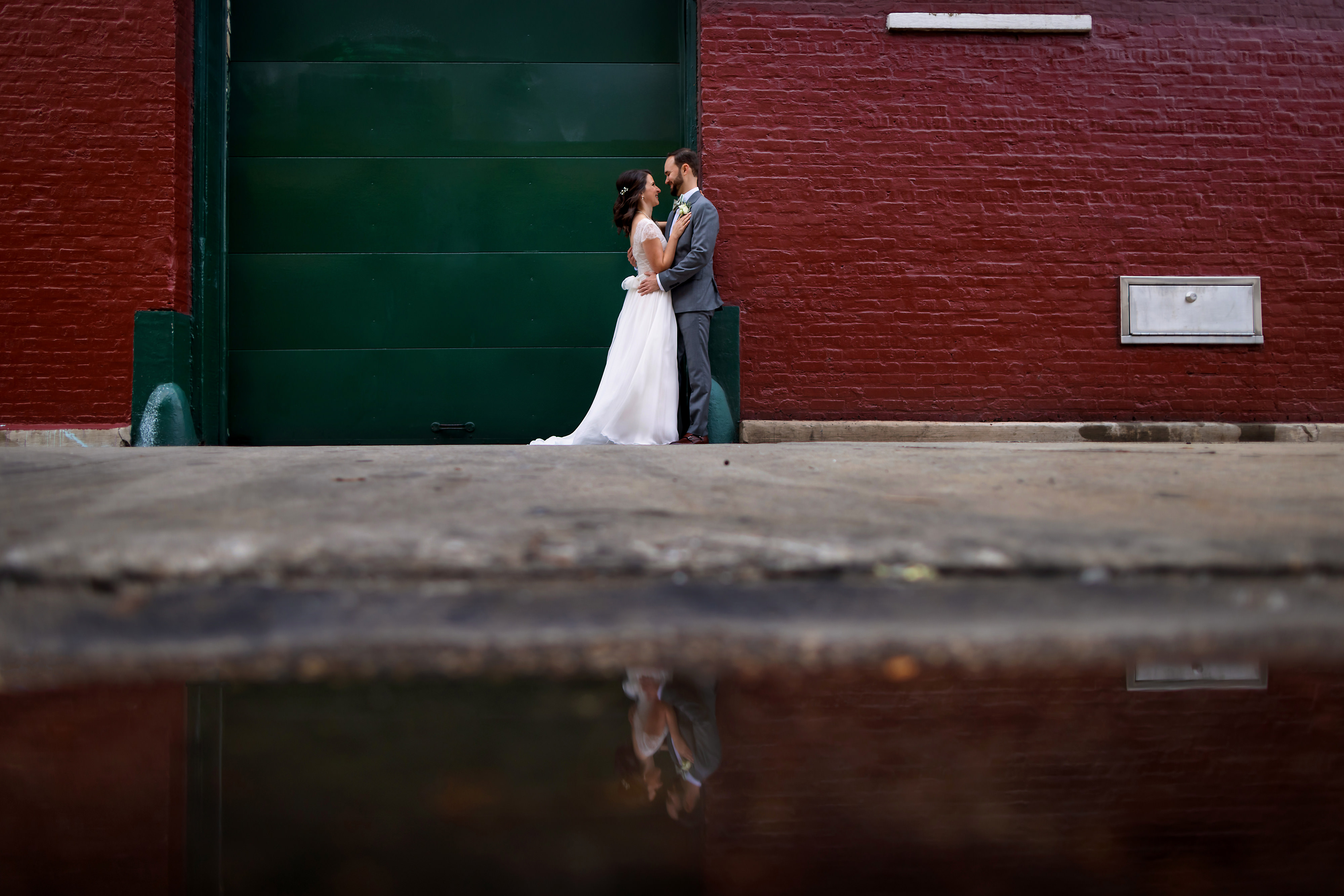 Bride and groom pose for a portrait under the El Tracks on Lake Street in Chicago's West Loop neighborhood.